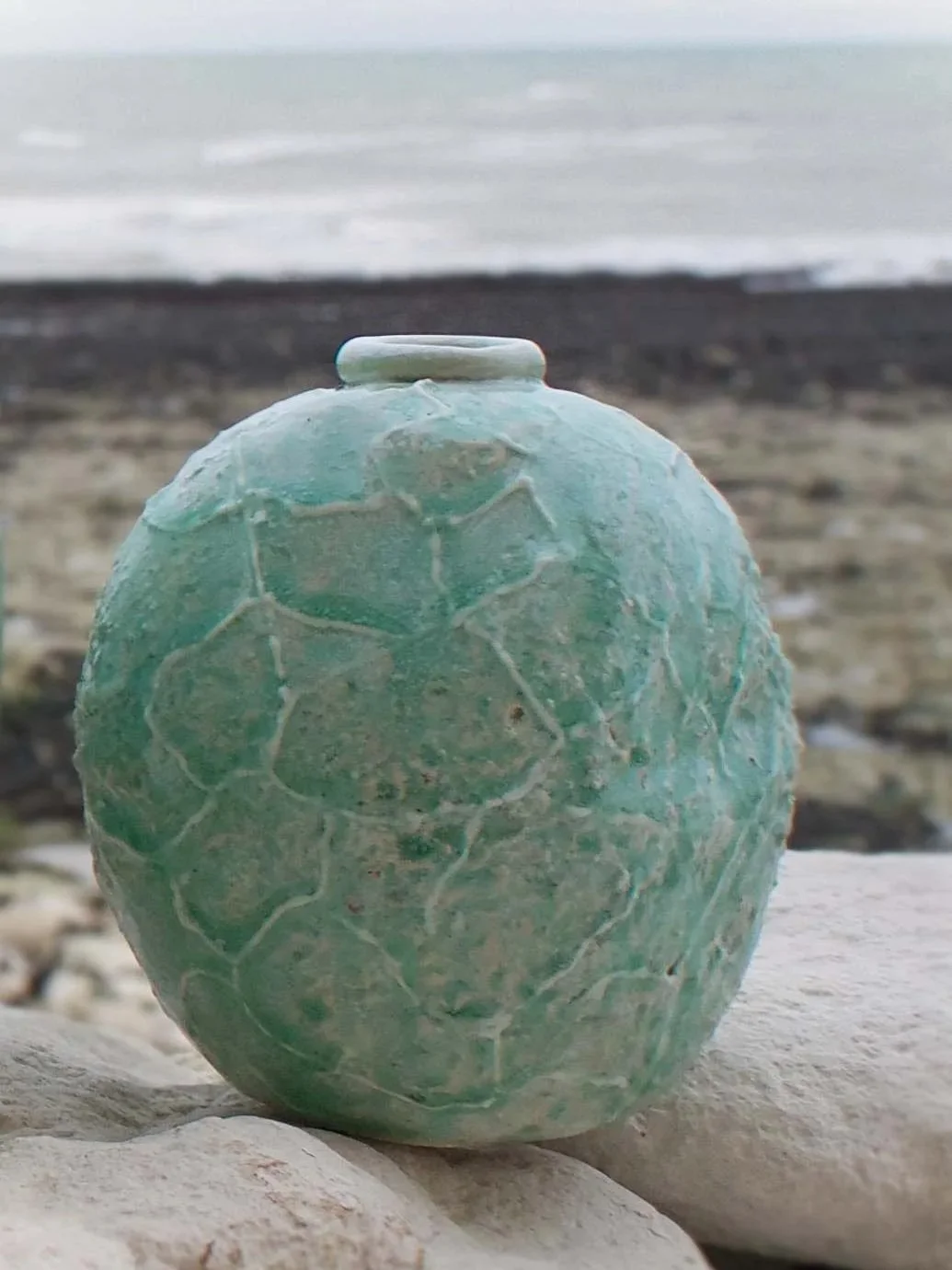 UNPOTE : Ocean Falling Tide No.3 
Handbuilt stoneware vessel shaped by the falling tide, rolled and pressed in ocean shallows. Its pale aqua ash glaze evokes the shimmer of retreating waves and the memory of saltwater light. Porcelain slip and wood a