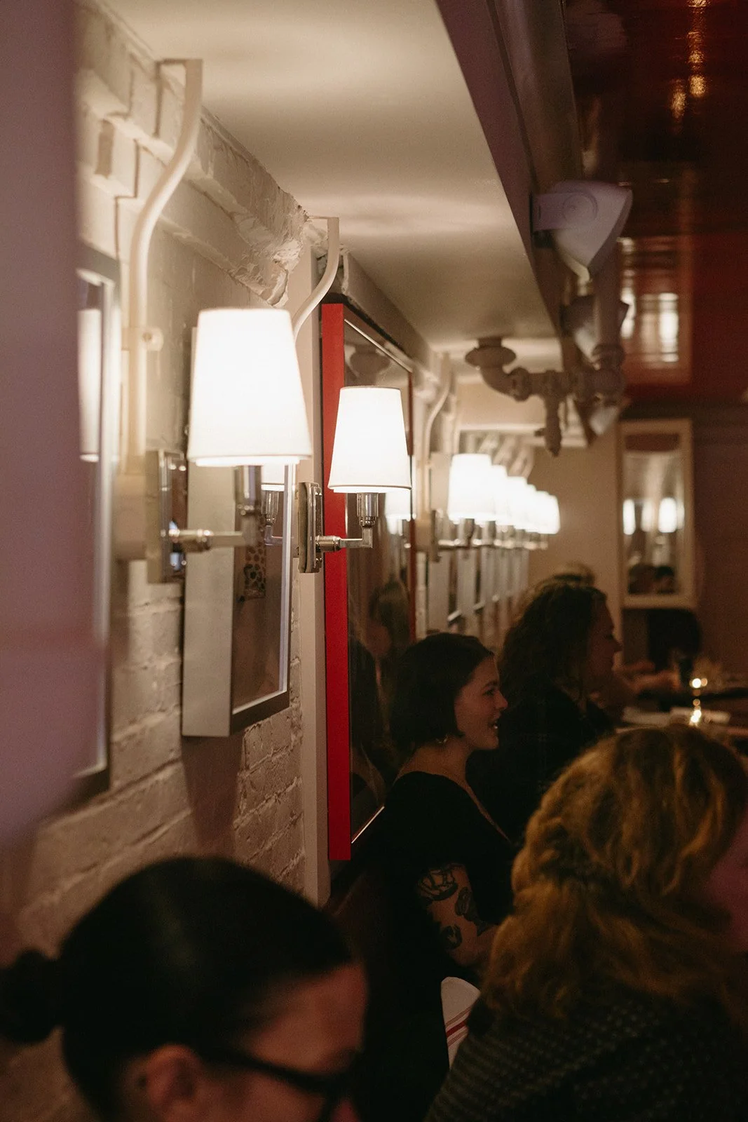 View of light sconces down wall. 