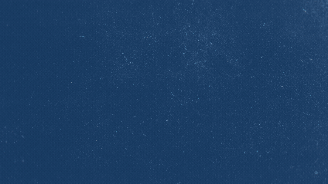 Blue surface with a hand holding a hockey puck.