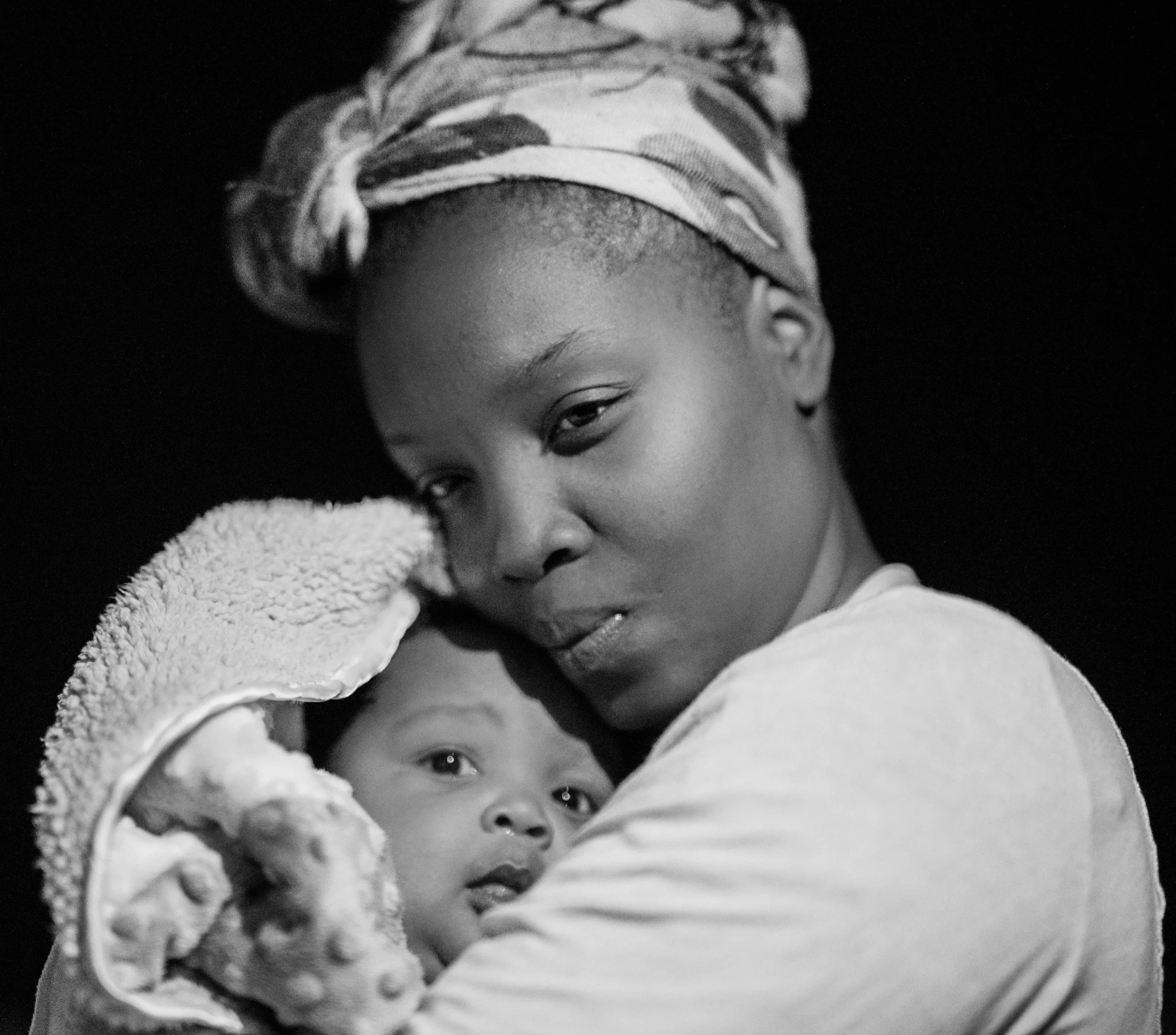 Christian mother holding newborn, faith-integrated postpartum therapy in Texas