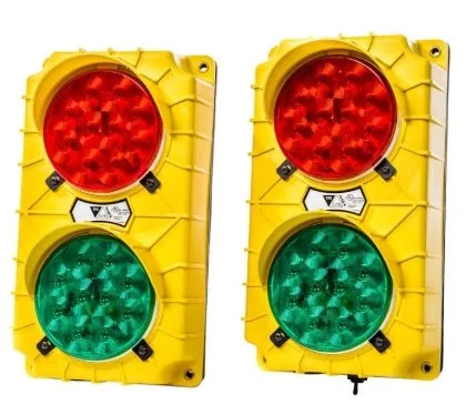 Two yellow loading dock traffic light signals with red lights on top and green lights on the bottom.