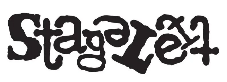 The word 'staged' written in black, stylized, distorted letters.