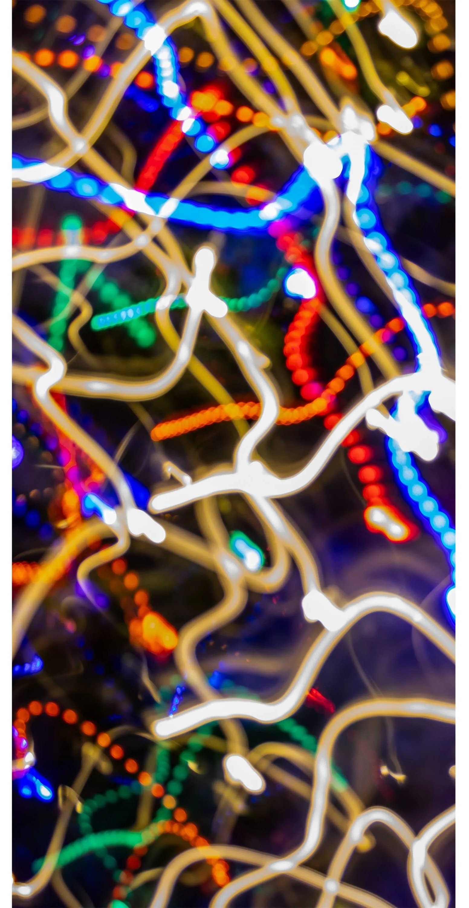 Blurred colorful Christmas lights creating a vibrant, abstract pattern.