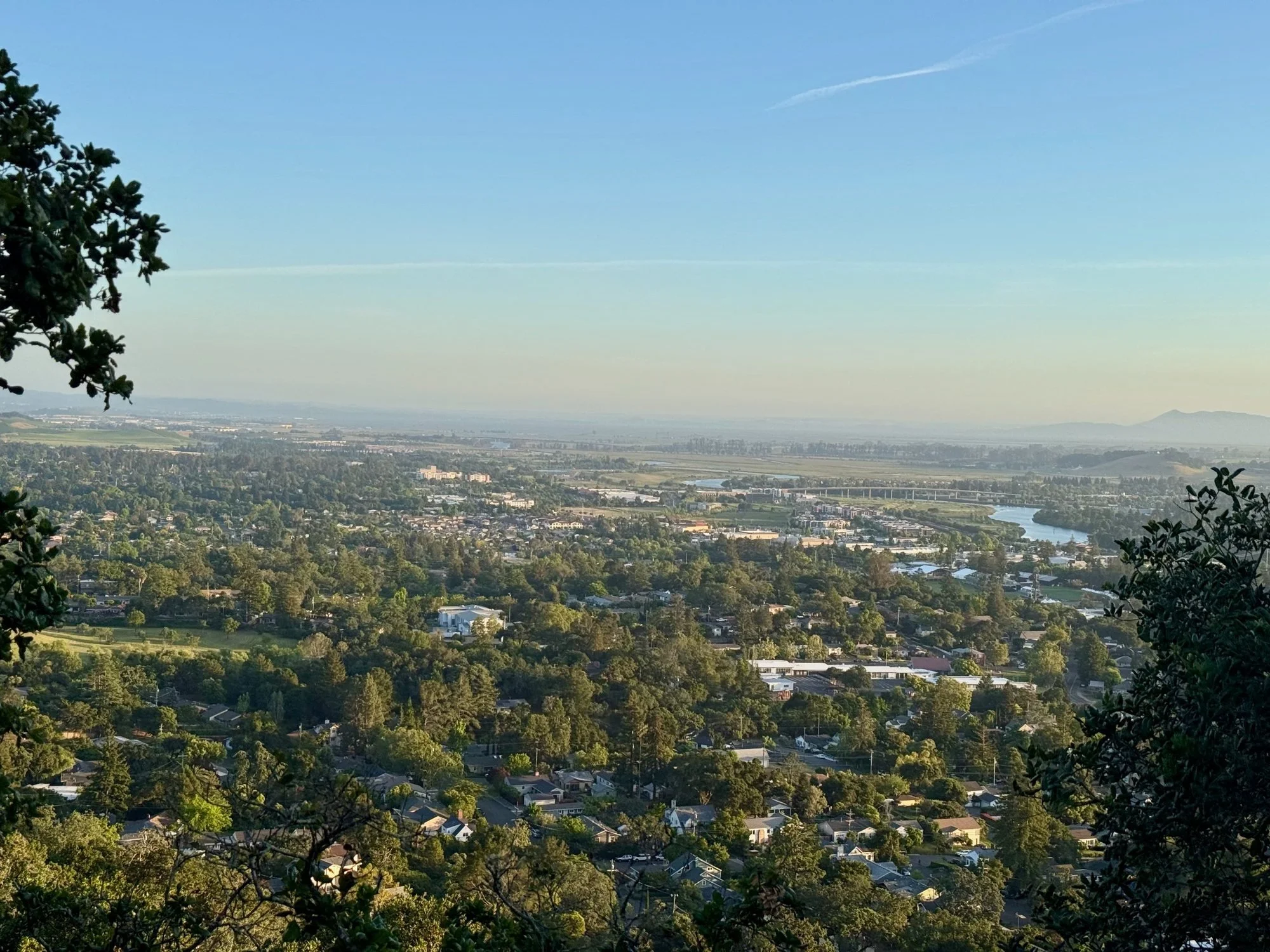 Evening view from a deck on Atlas Peak over Napa, the river winding south toward the bay, and Mt. Tamalpais on the horizon