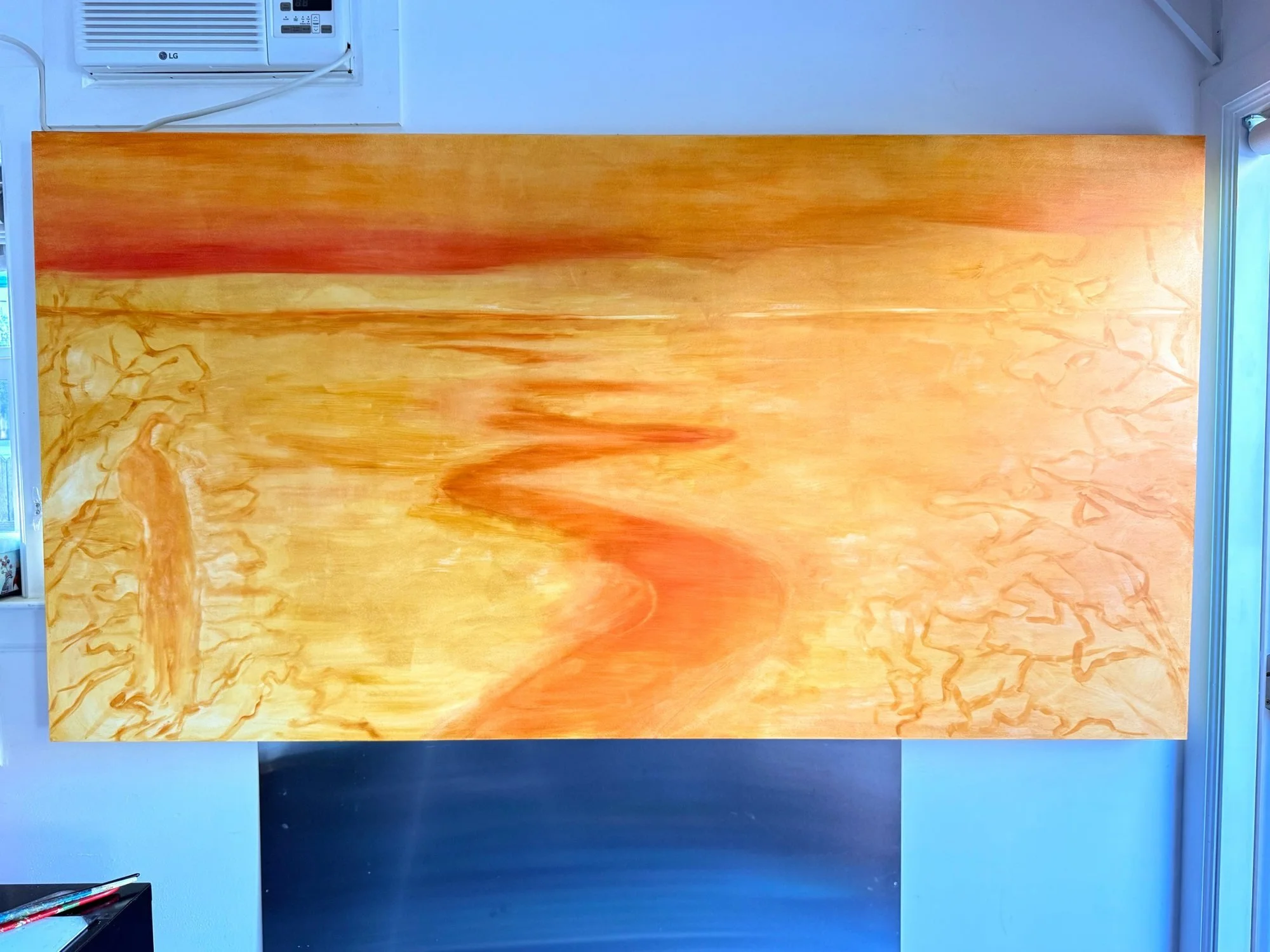 The 42 x 80 inch panel on the studio wall, with first layers of ochre and orange underpainting.