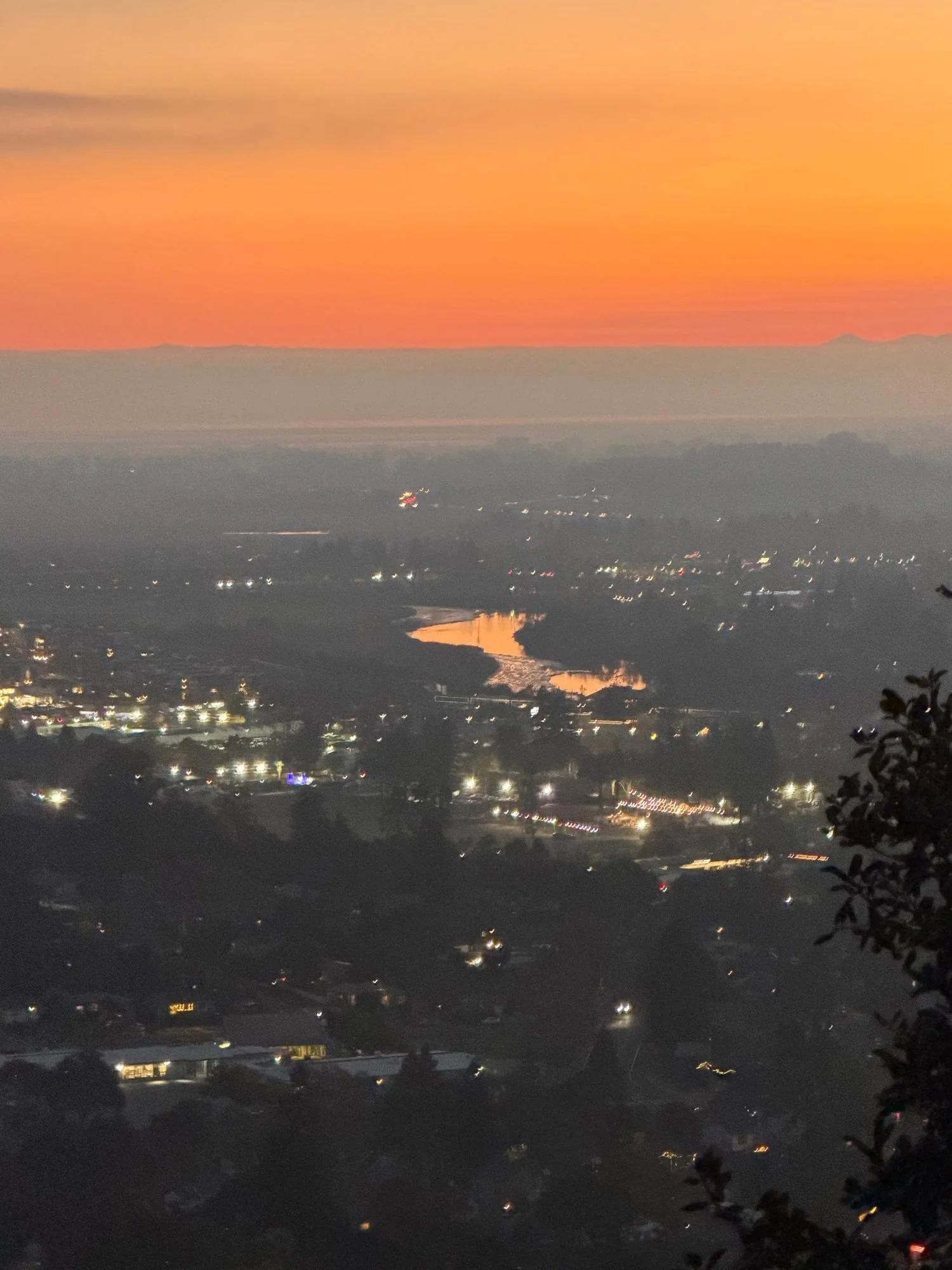 Clients’ photo of the Napa River lit orange by the setting sun.