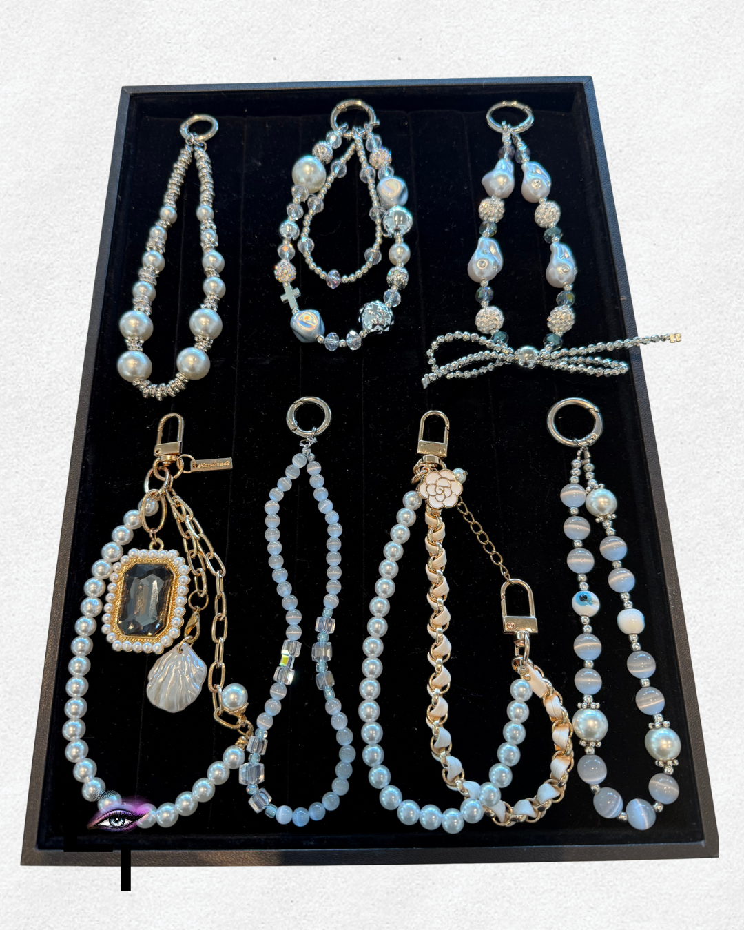 Collection of pearl and beaded jewelry, including necklaces, bracelets, and earrings in a display box.