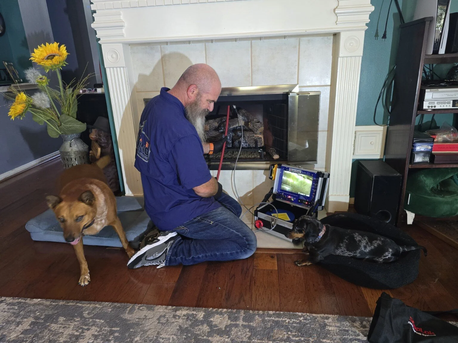 Craig Dornak performing a camera-assisted fireplace and chimney inspection.