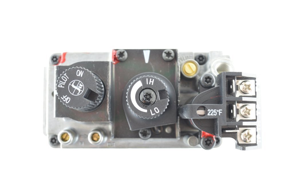 Close-up of a temperature control device with knobs and electrical connections, labeled with temperature settings and symbols for heating and pilot.