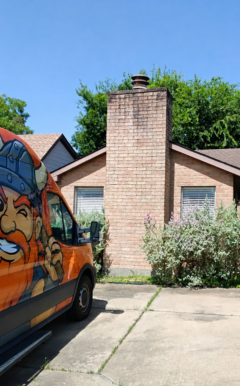 Viking Chimney Solutions service van beside a residential masonry chimney.