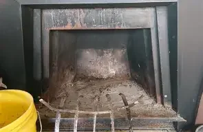 Empty fireplace with soot and ashes