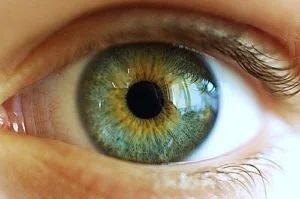 Close-up of a human eye with green and hazel iris.