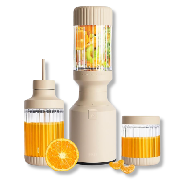 A sand colored portable blender with a blending container filled with orange and yellow fruit chunks, a half orange, and two mandarin segments placed beside it.