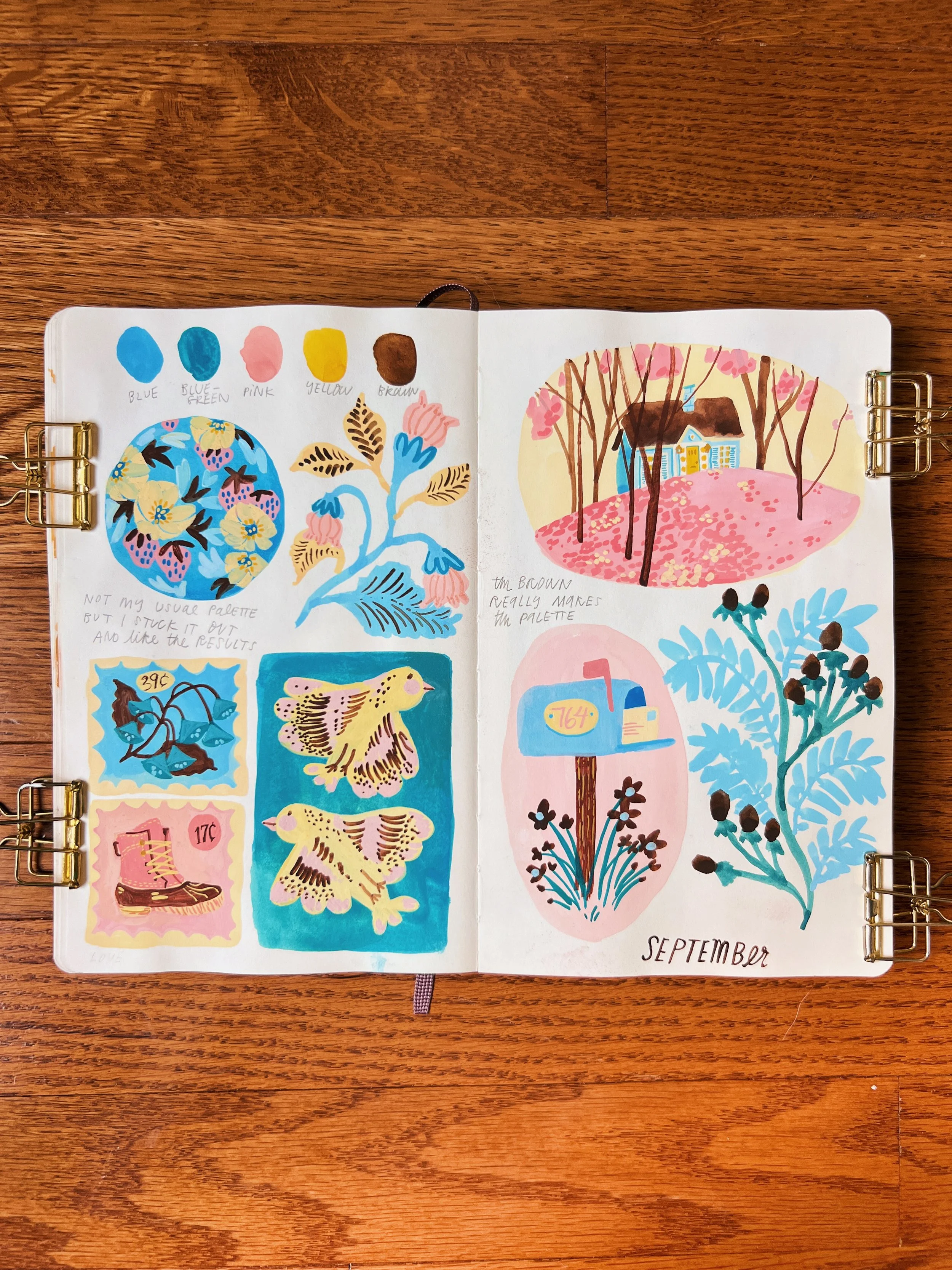 An open sketchbook shows small gouache paintings of birds, landscapes, and flowers done in a soft, primary color palette