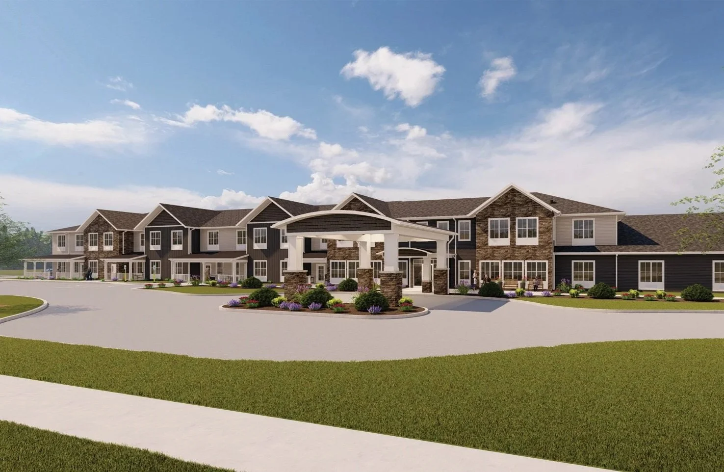 Modern multi-story assisted living or senior housing complex with a covered entrance, landscaped garden, and wide driveway under a blue sky with scattered clouds.