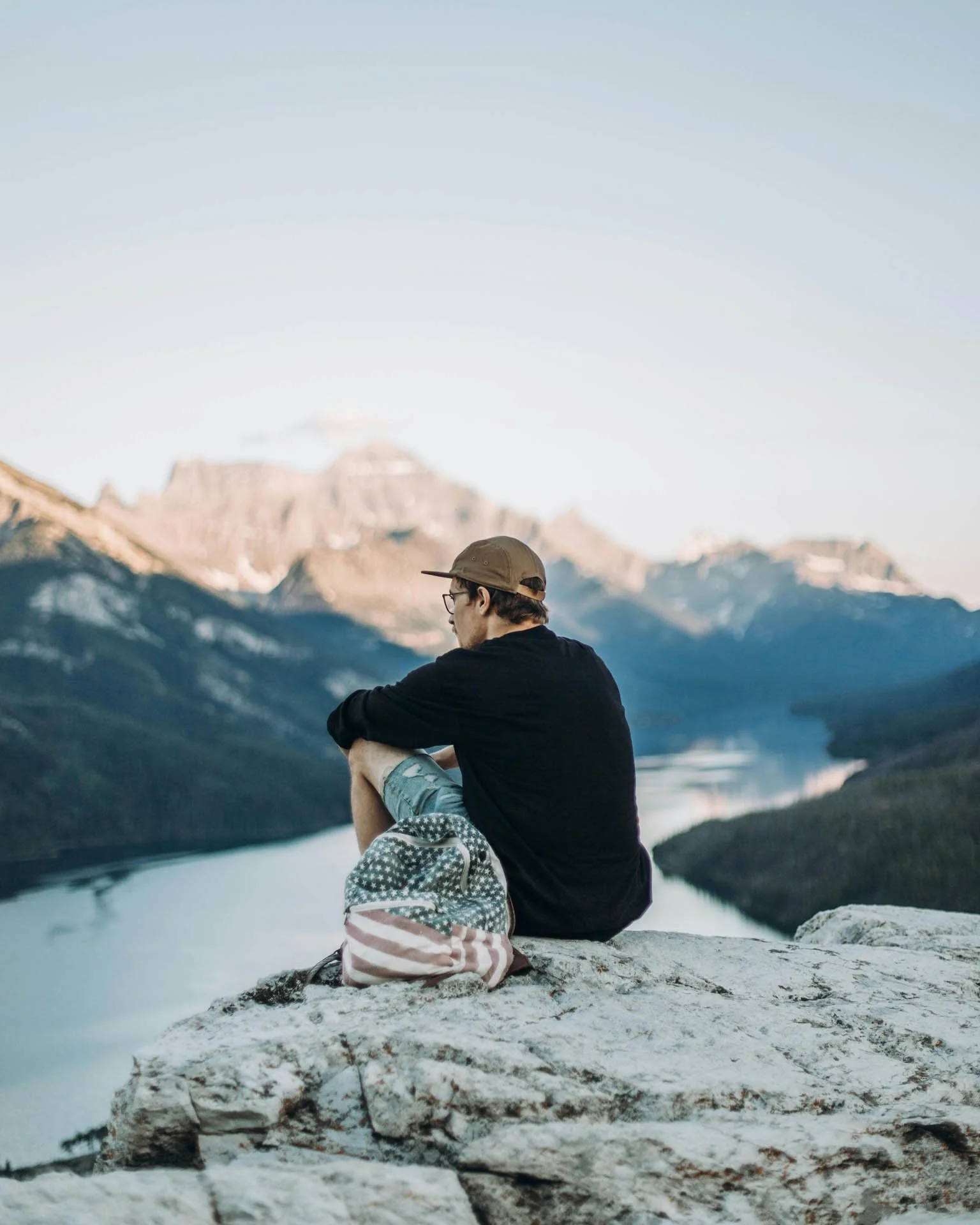 man sits in contemplation atop a mountain similar to how it feels to face your fears and start therapy