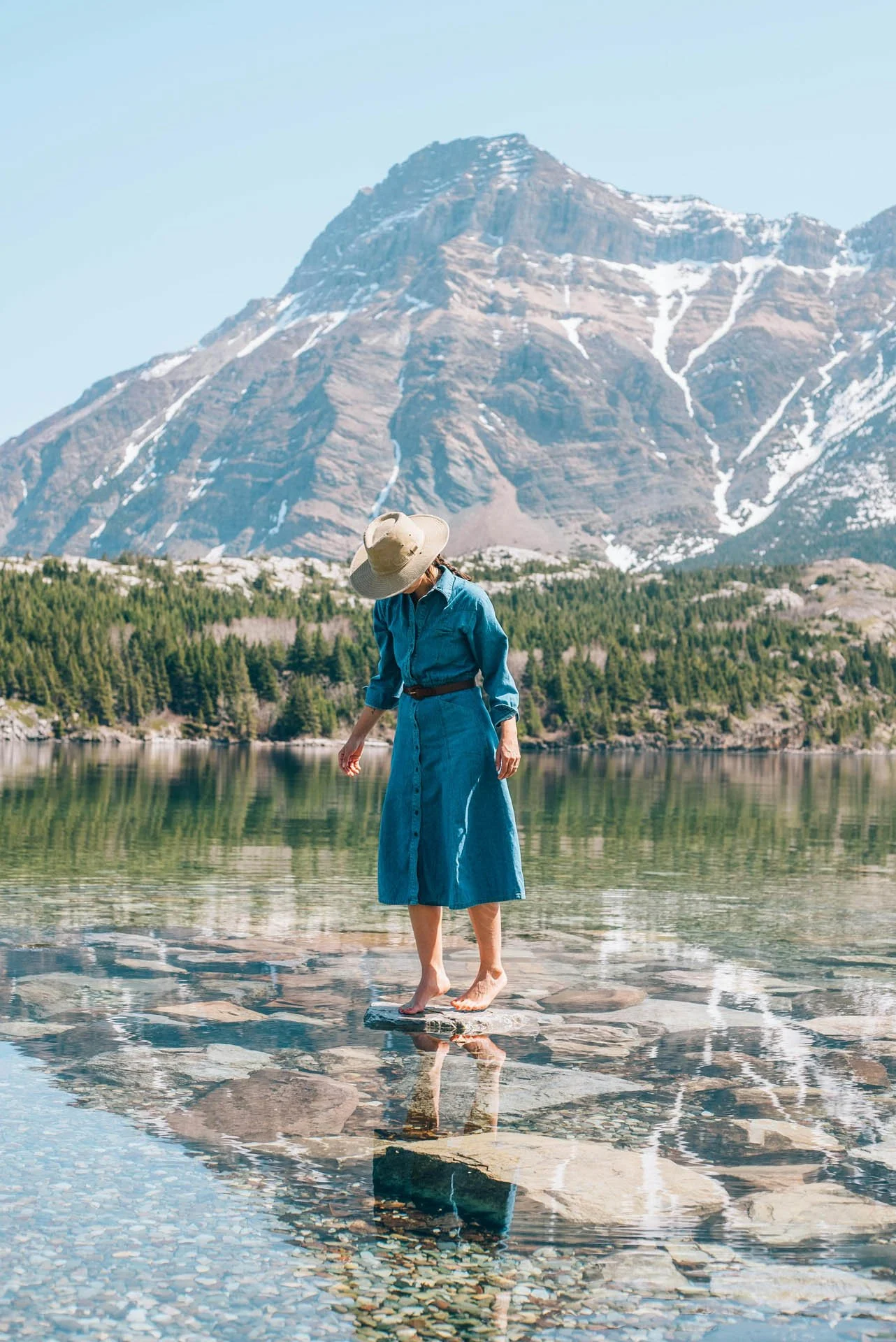 woman stands ankle deep in fresh water to represent
