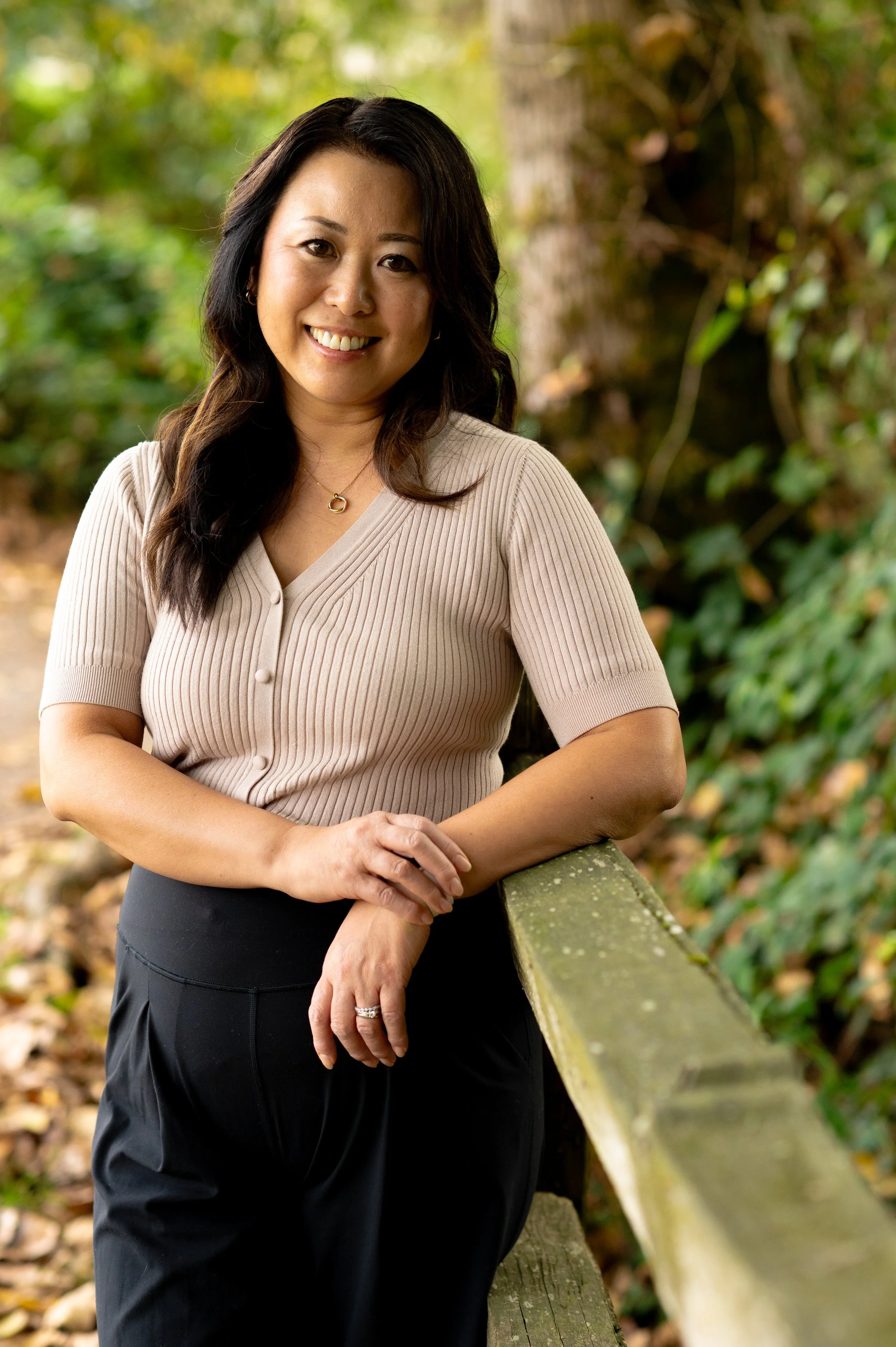 yoko gifford smilin in an outdoor setting with trees and greenery all around