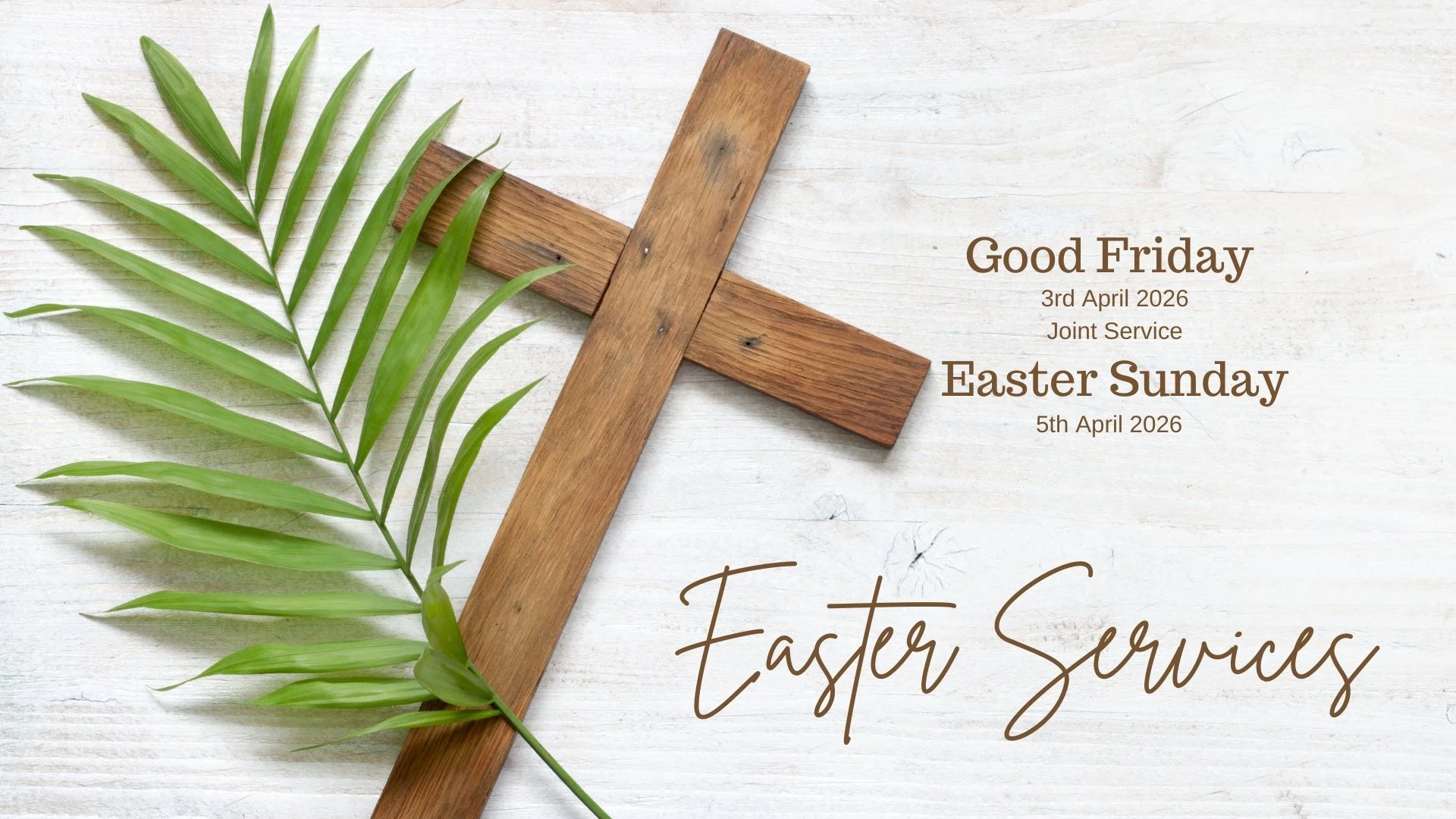 A wooden cross and a green palm leaf on a white wooden background with text wishing a good Friday and Easter Sunday for April 3rd and 5th, 2026.