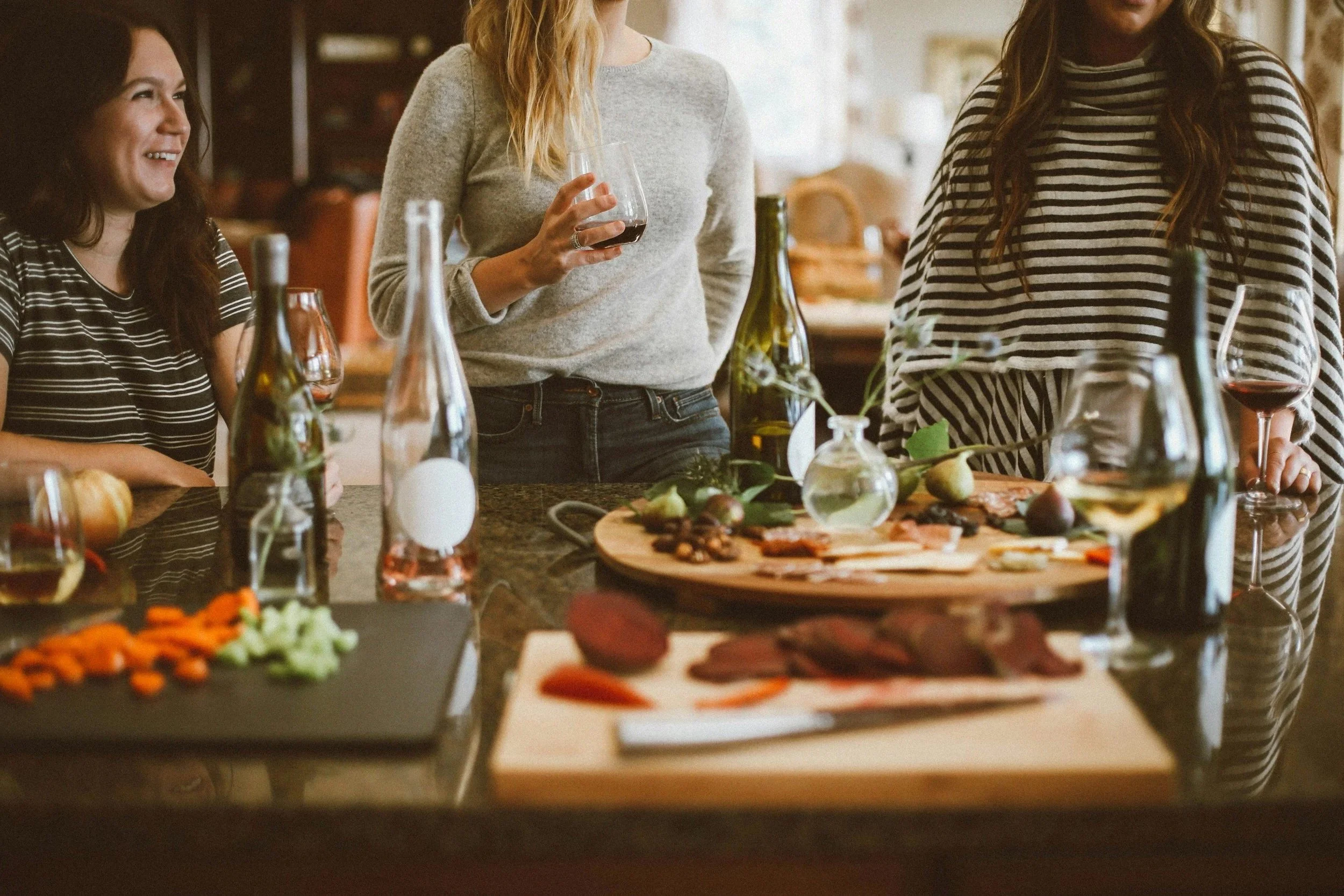 Group of people eating together and enjoying conversation at an Alpha Course gathering, creating community and discussing life's big questions.