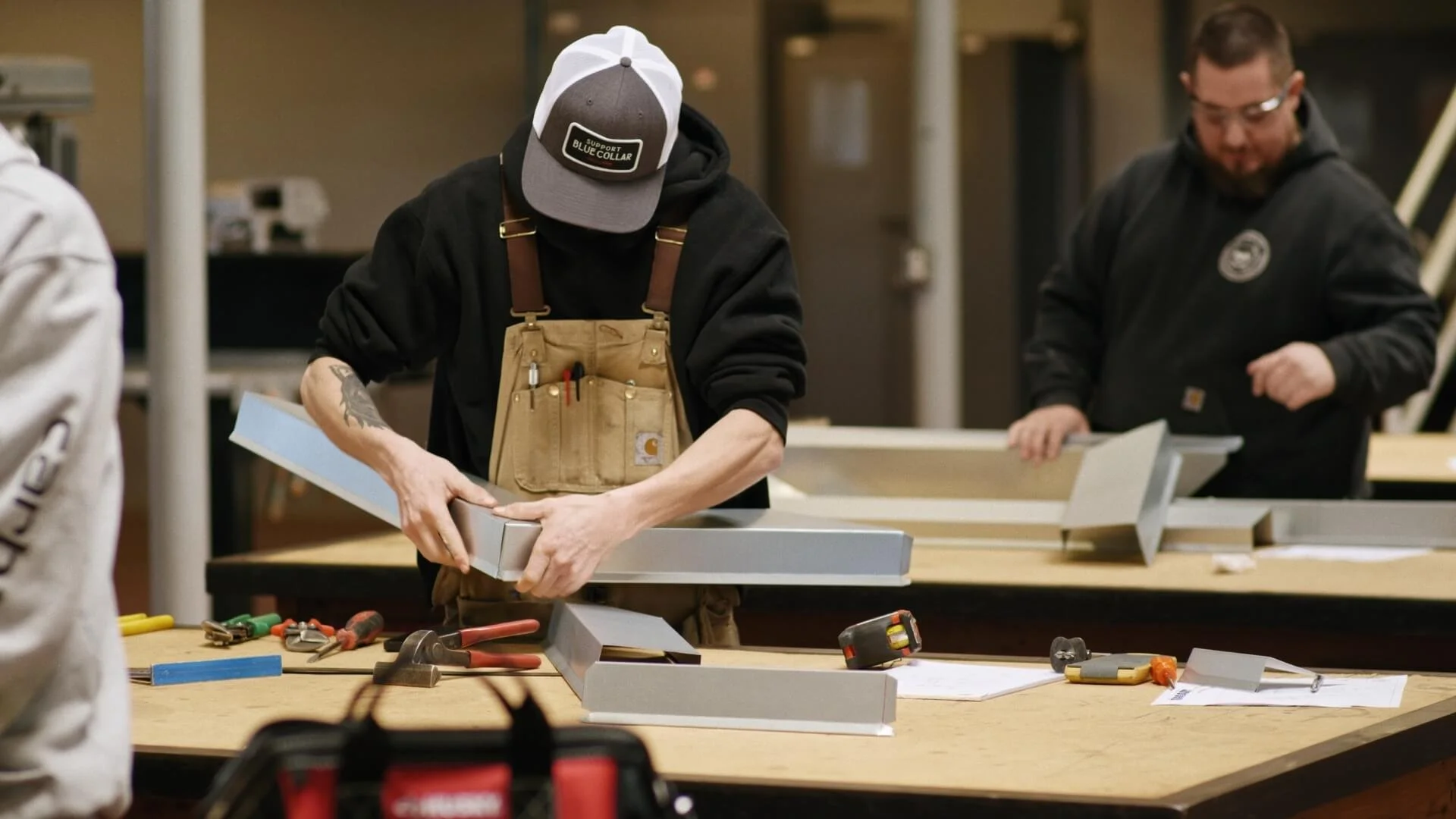 Two men working on a woodworking project at a workshop