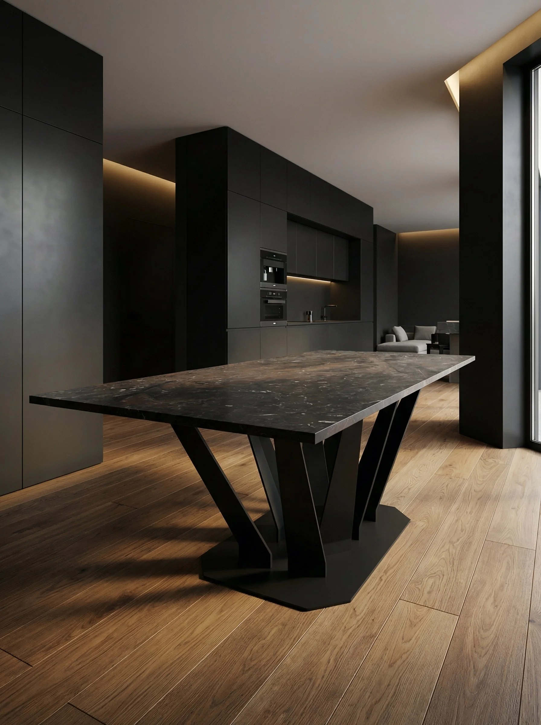 Interno moderno di una cucina con mobili neri e piano di marmo scuro, illuminazione soffusa, pavimento di legno chiaro, vista parziale su un'area salotto con divani e grandi finestre.