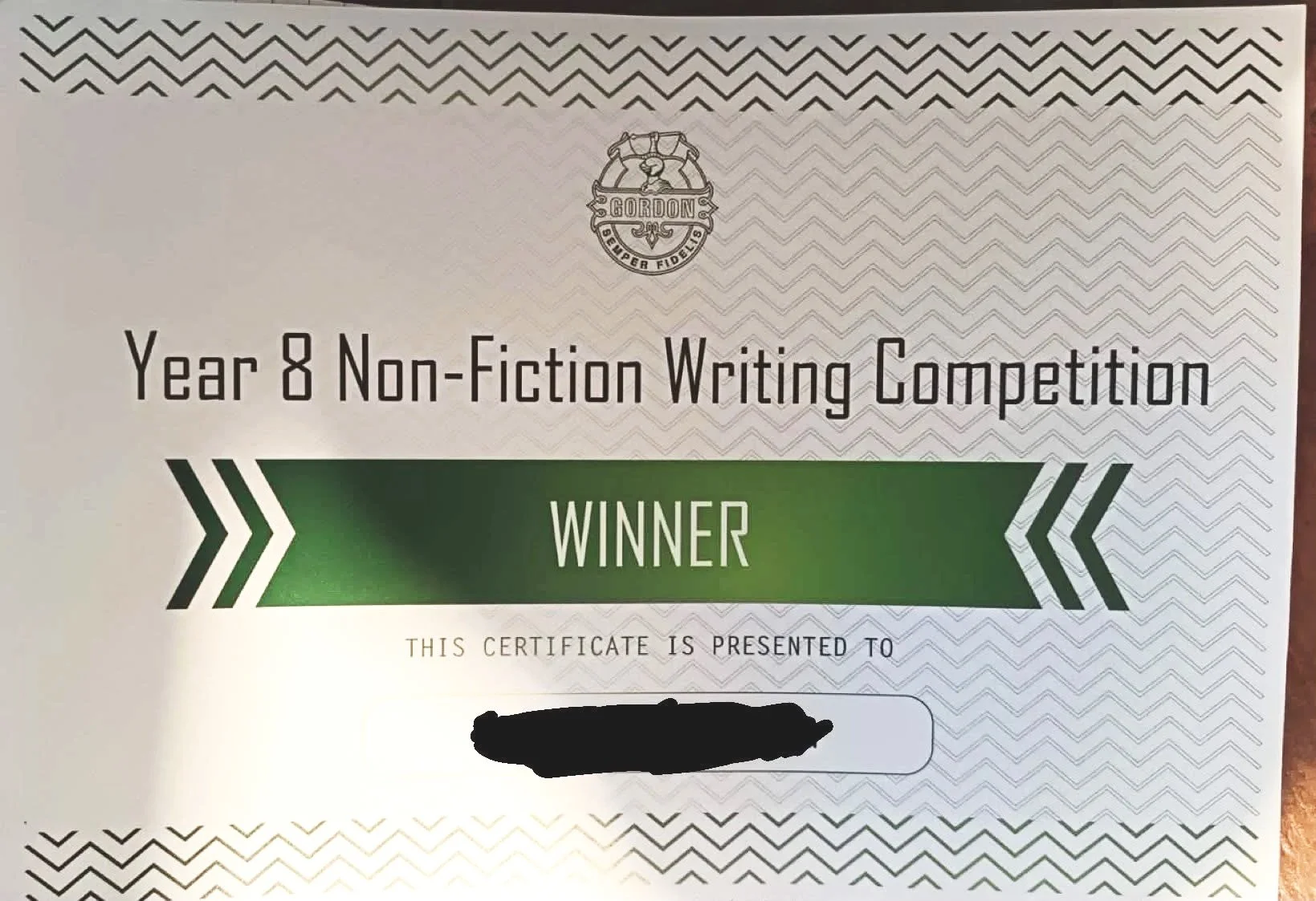 Image of a student certificate that reads: Year 8 Non Fiction Writing Competition. The word Winner appears below in capitals with a green background.  The Gordon school logo is above