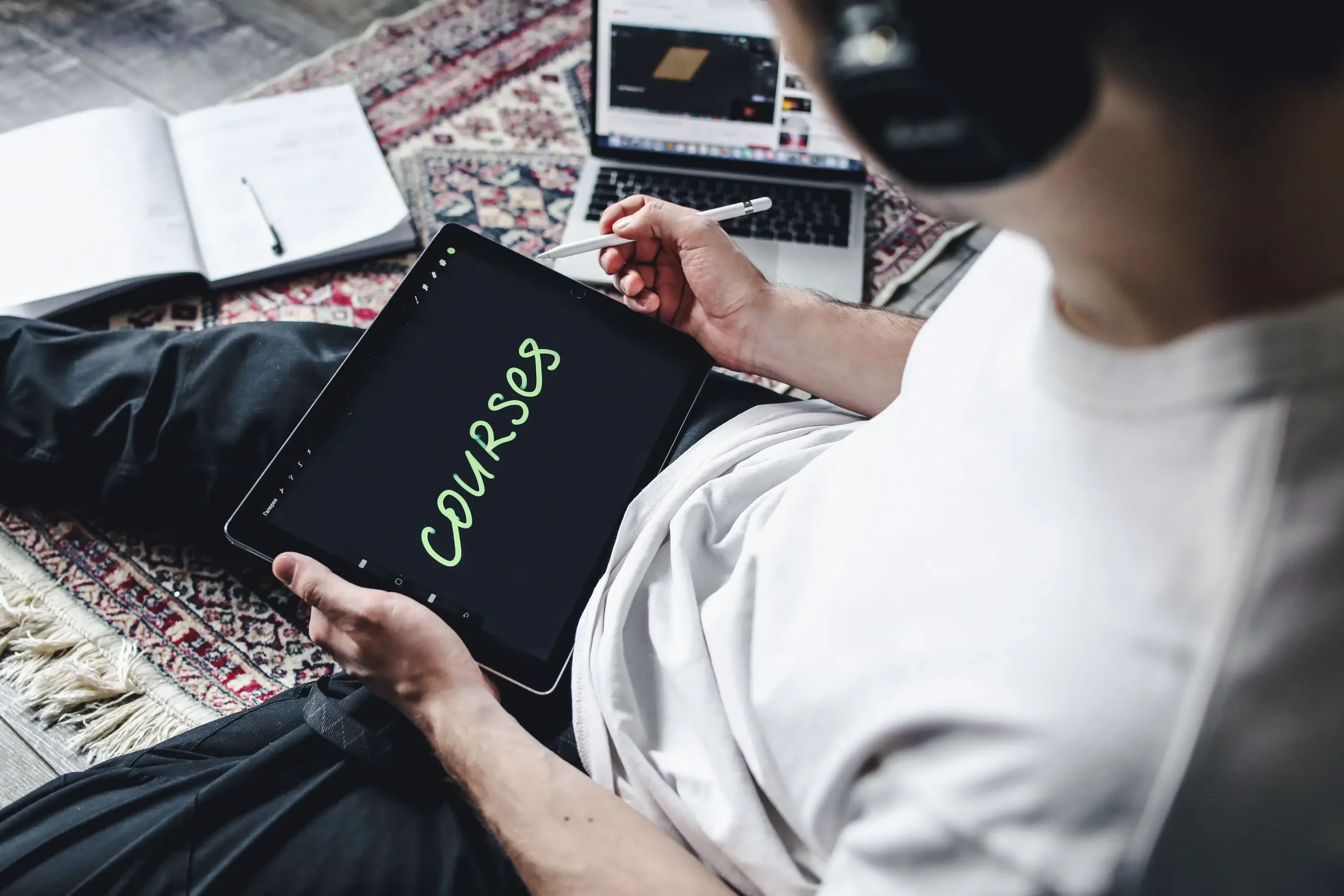 Therapist creating an online course on a tablet while planning how to avoid common online course launch mistakes.