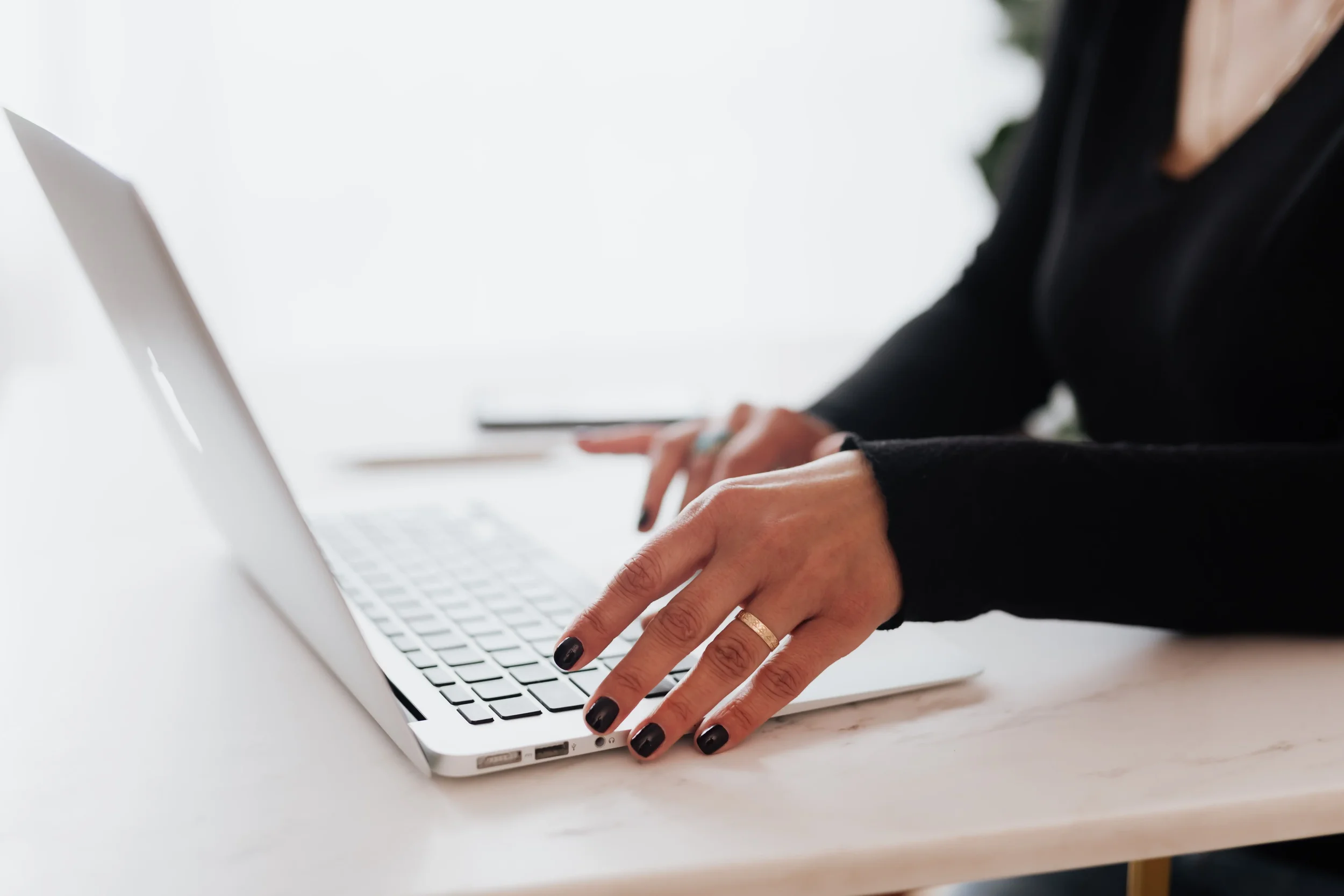 : Writing email content on a laptop, reflecting a therapist’s effort to turn website visitors into interested subscribers through useful, practice-focused communication.