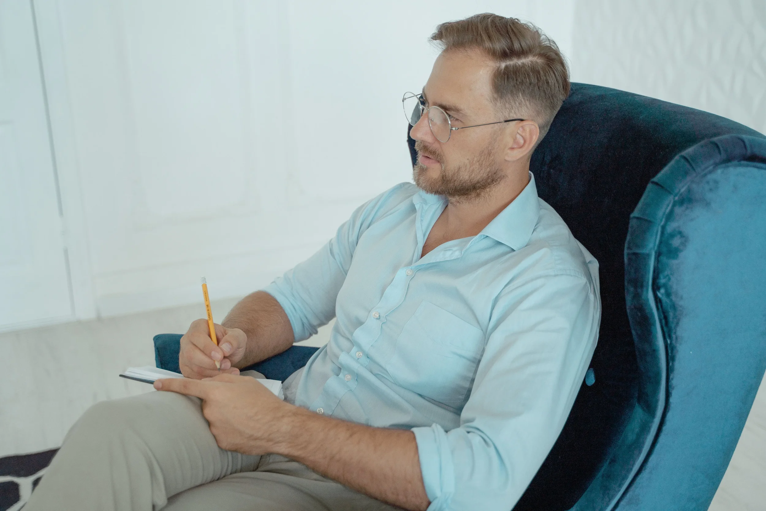 Therapist taking notes in a private practice office, representing an established practice reviewing whether its current website needs a redesign.