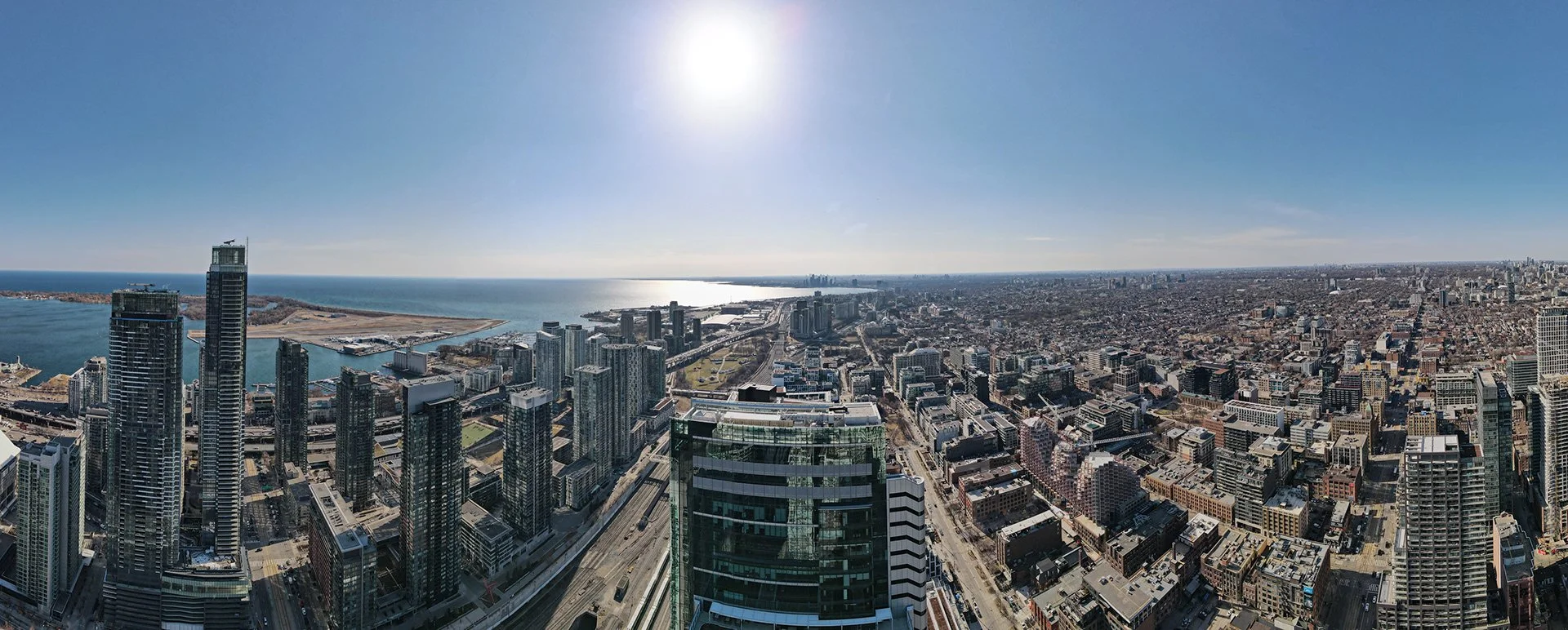"180° panoramic view of downtown Toronto, showcasing high-rise buildings and the city’s architectural character under open skies."