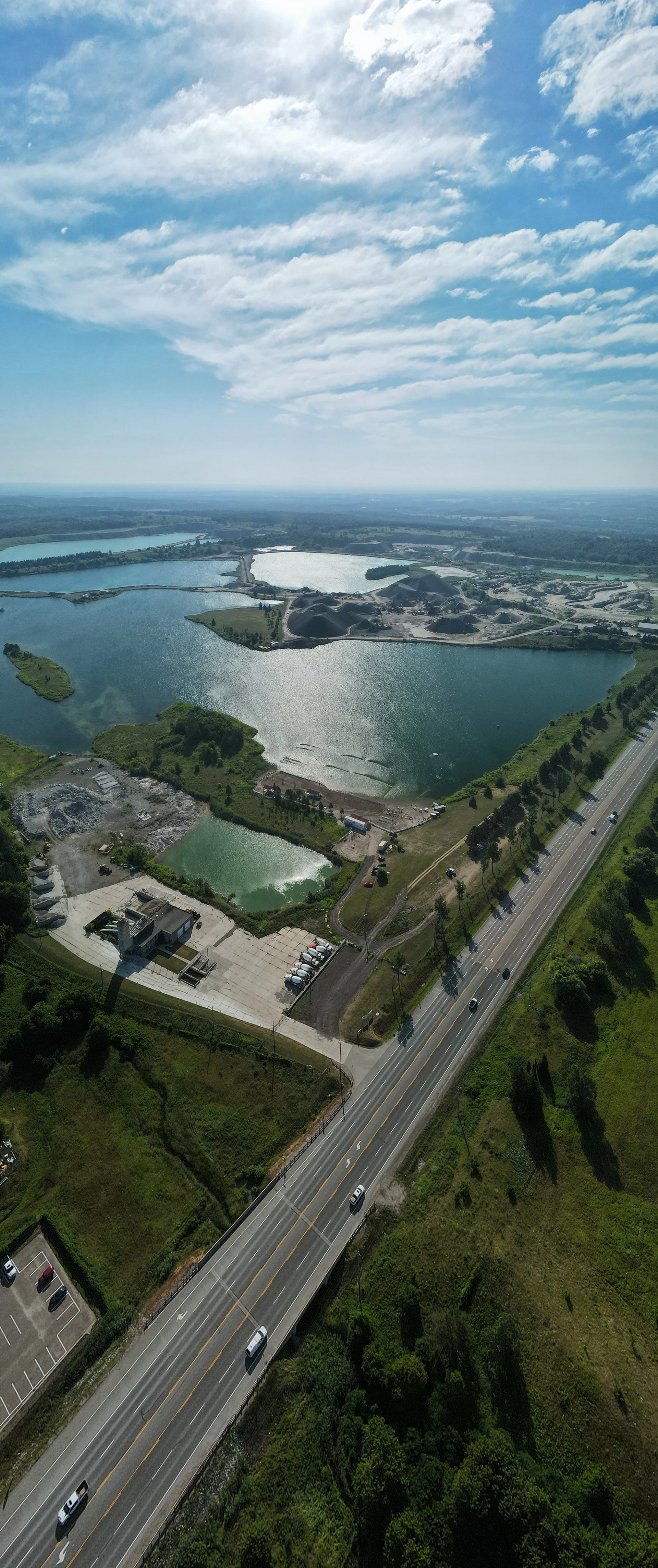"Aerial panorama of lake dredging and active construction work in a city environment, highlighting urban development and infrastructure upgrades."