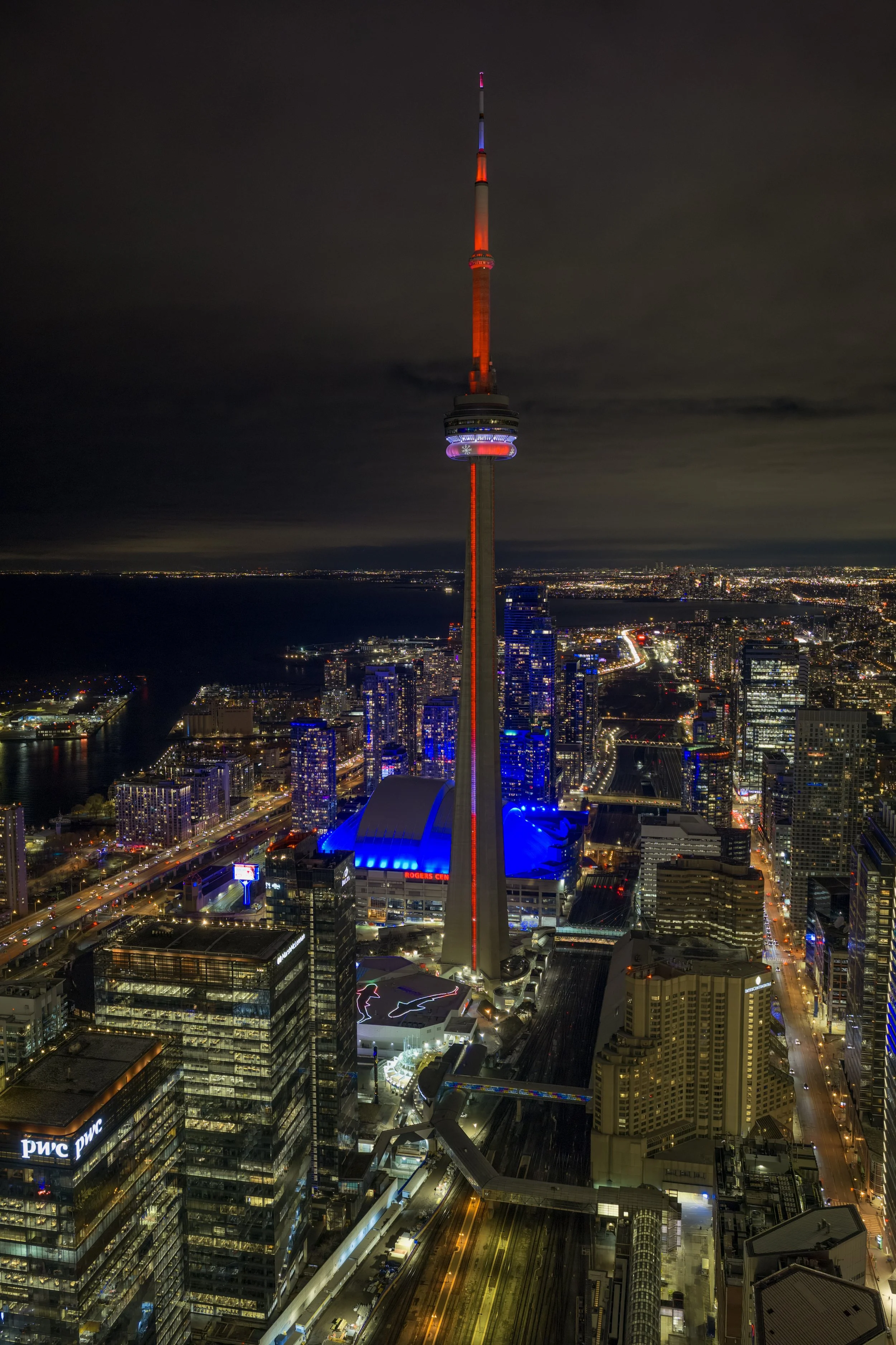 Colorful CN Tower with Rogers Centre below it