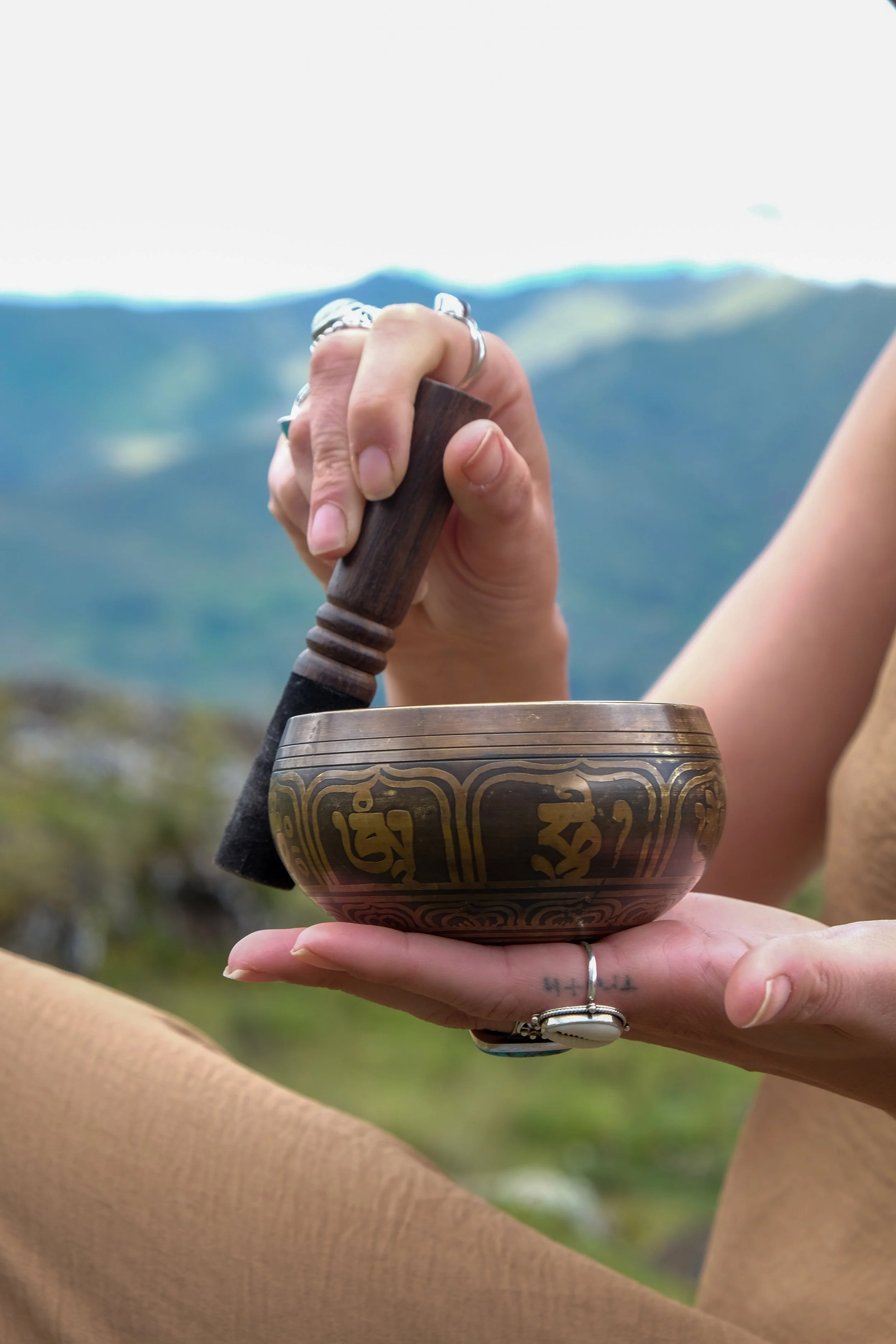 Louka's hand holding a sound bowl making ambient noise.