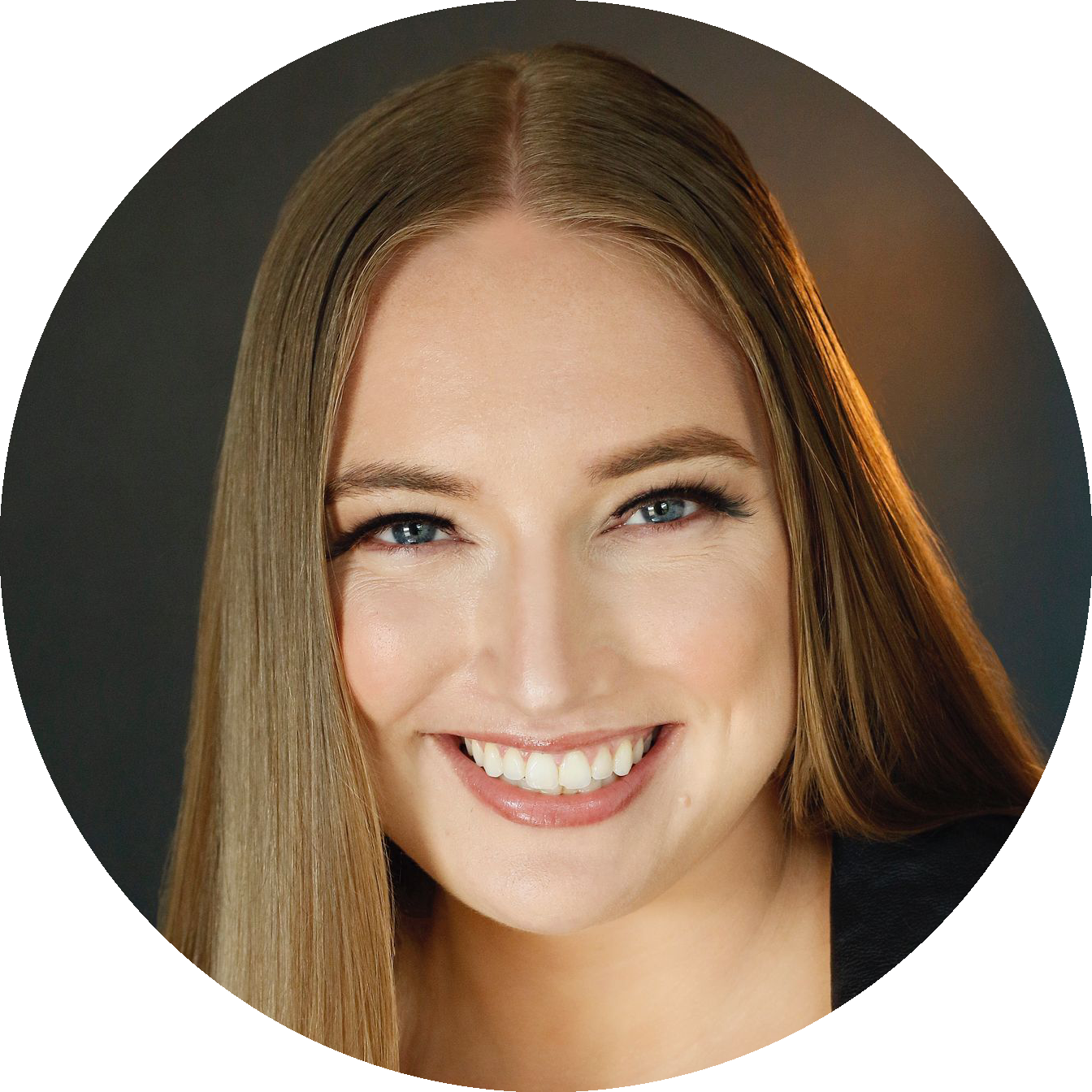 Alicia Topolnycky, co-host of the 0g-SPOT podcast, smiling in a professional headshot with long straight light brown hair, wearing a dark top against a neutral studio background.