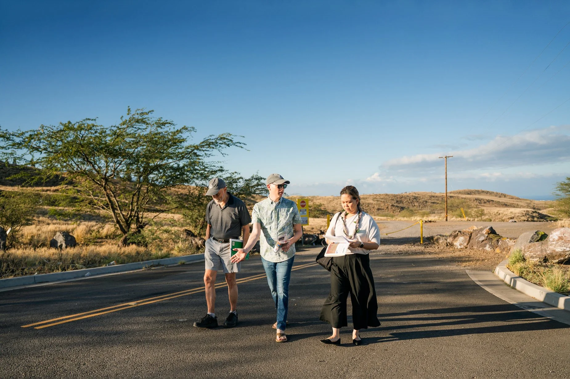   Photo Credit: Wildfire Safety Advocates/ Aislinn Chalker     Walking discussion at the northern edge of Waikōloa Village, where distance, density, and exposure to wind-driven wildfire highlight the urgency of a second evacuation route.  