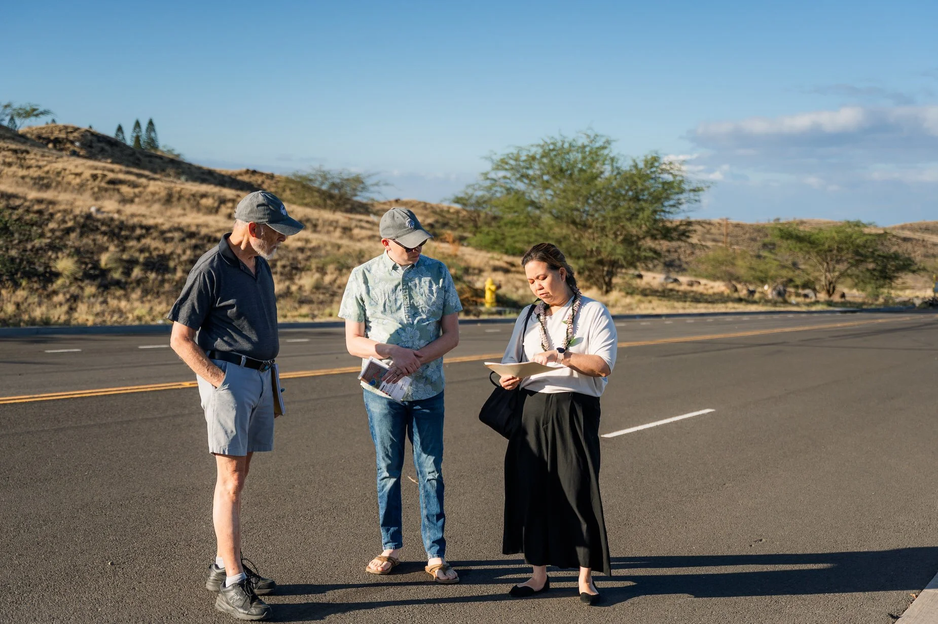   Photo Credit: Wildfire Safety Advocates/ Aislinn Chalker     On-site conversation with Congresswoman Tokuda overlooking current and planned development areas near Kamakoa Drive, where new housing is proceeding ahead of a completed second access roa