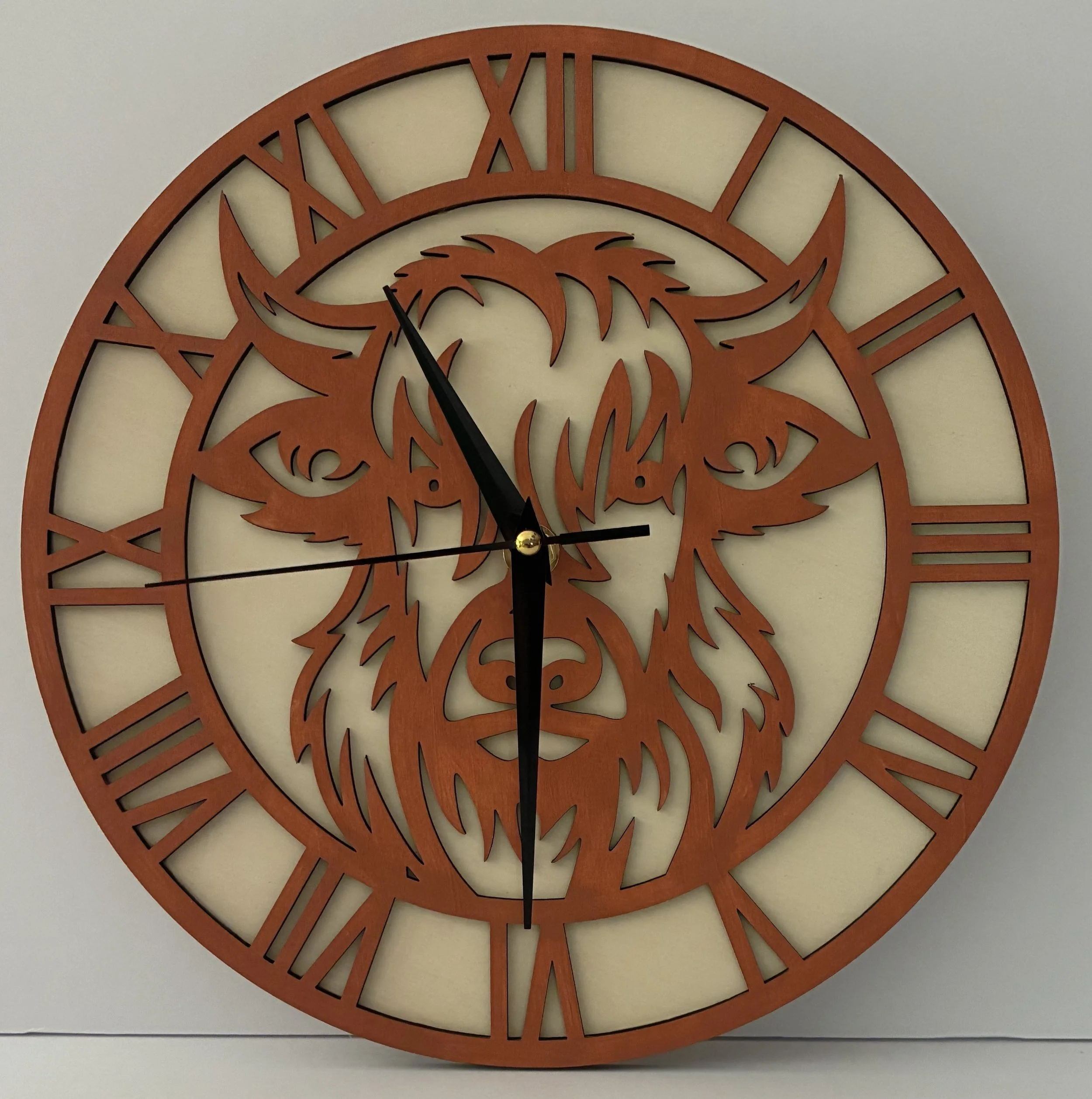 Round wall clock with Roman numerals and a bear's face carved in wood at the center.