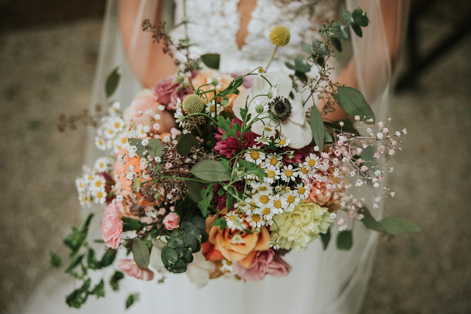 Bride holding an Ash + Ether bouquet at a Colorado wedding, featuring soft, romantic seasonal florals.