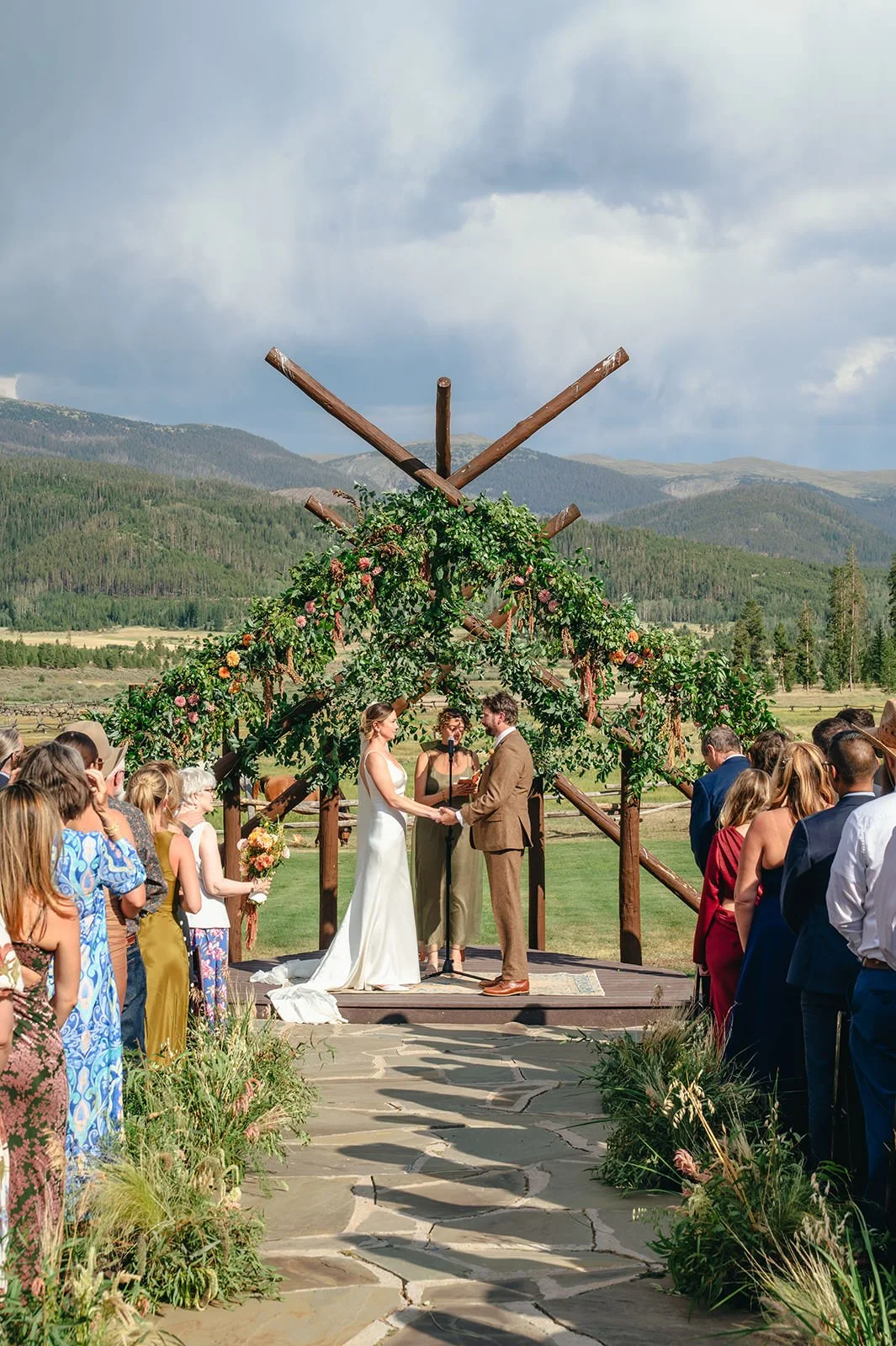 A couple holding hands as they say their vows at their wedding