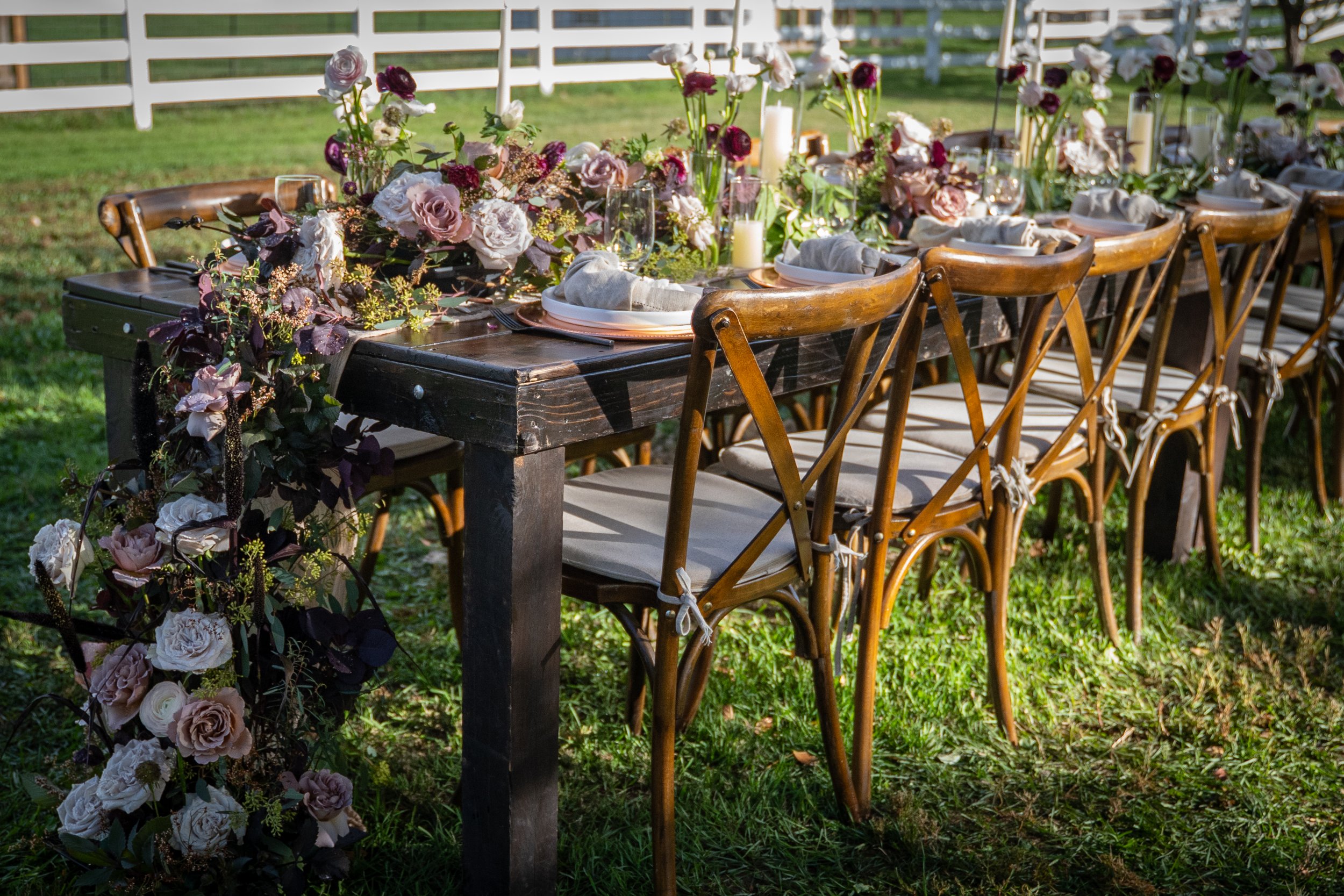 Ash + Ether outdoor wedding tablescape with wooden chairs and seasonal Colorado florals.