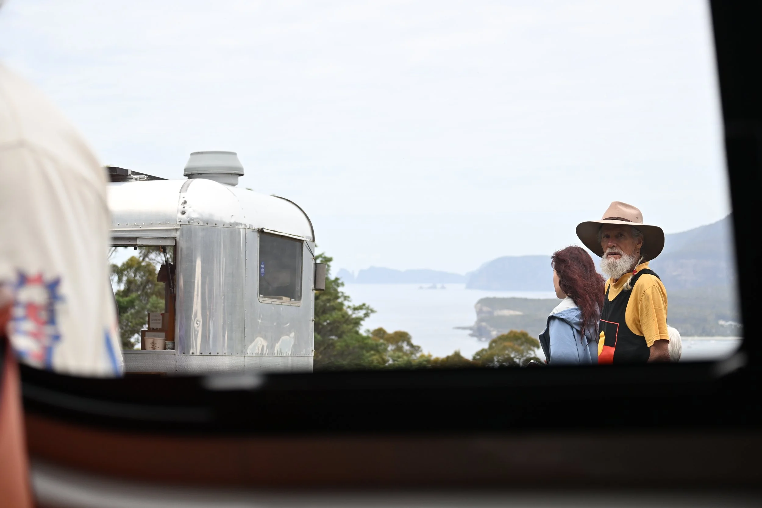A brim of coffee, hat and coastline. Hobart, Tasmania. Feb 2026 