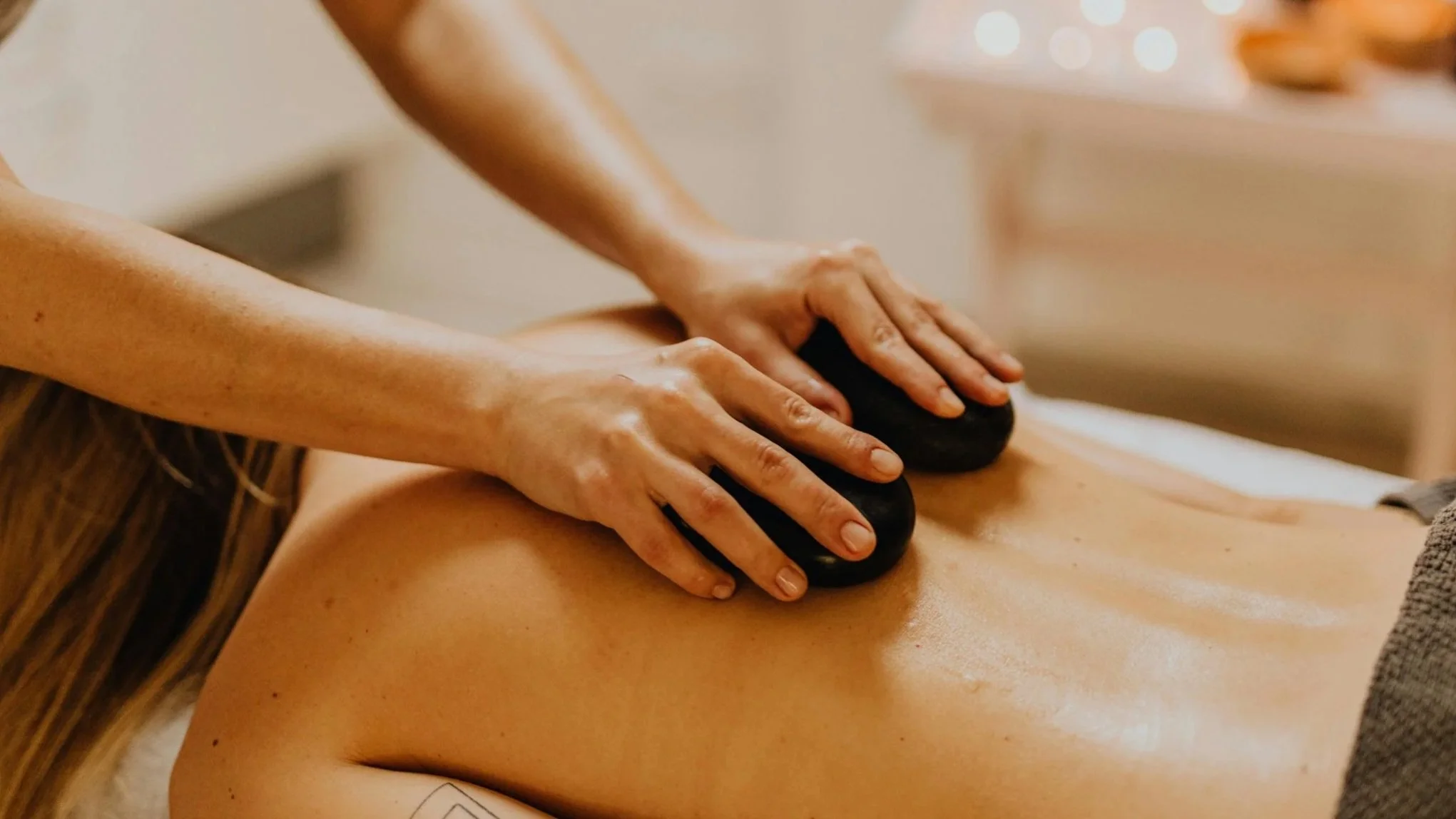 Registered massage therapist providing back massage treatmen