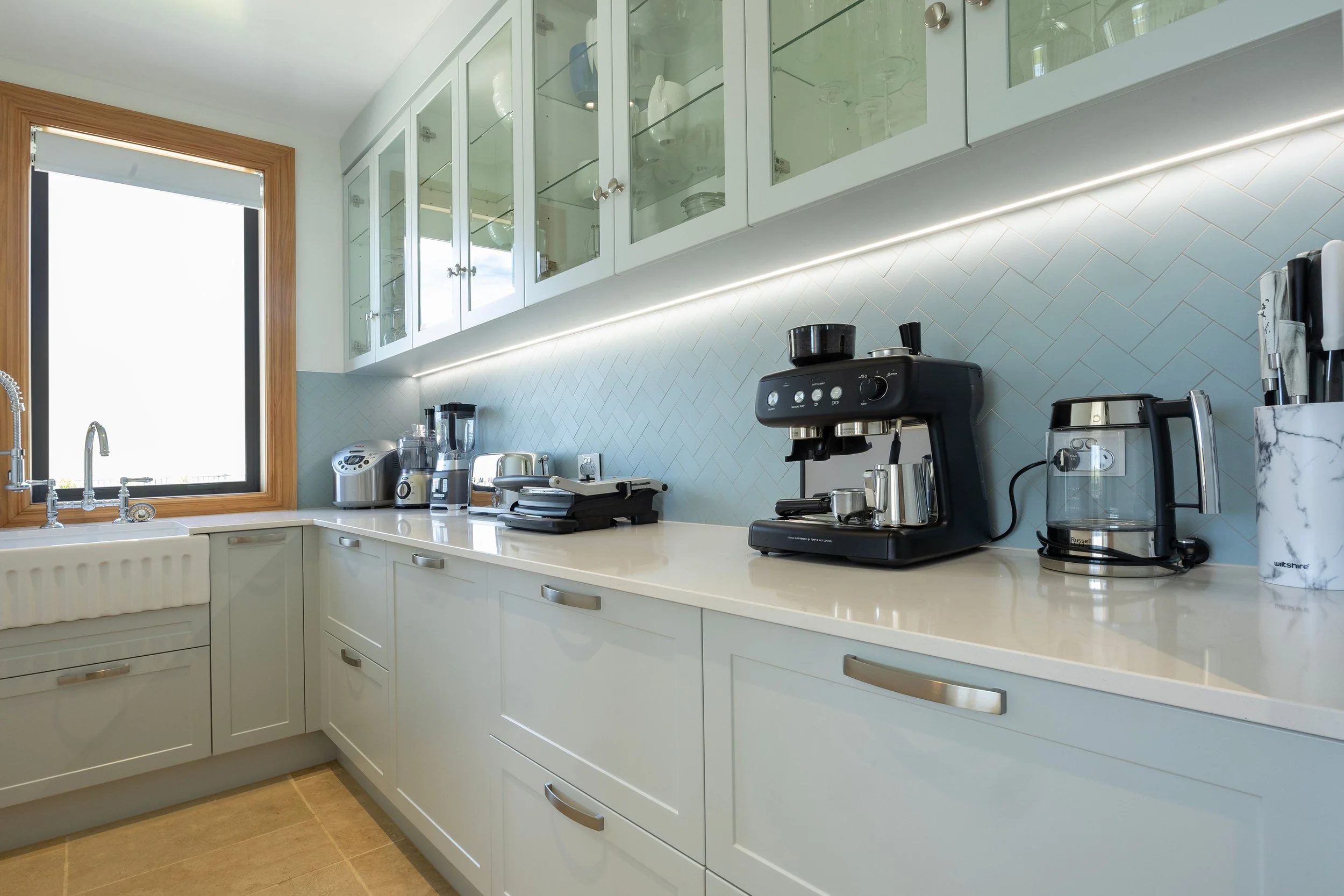 The kitchen, dining space, and well-equipped butler’s pantry are thoughtfully designed to support everything from relaxed in-house catering to professional-level cooking