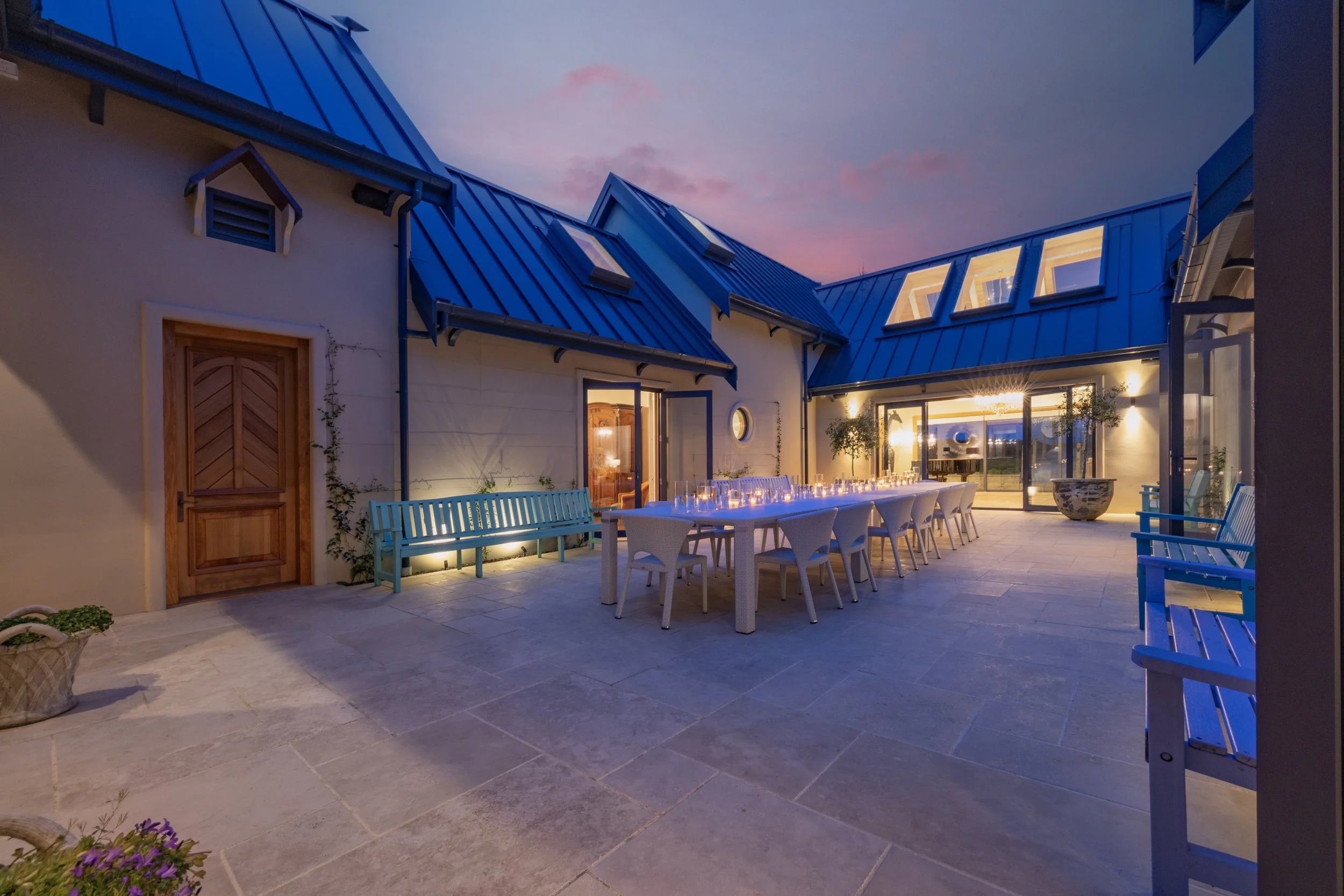 An outdoor patio and dining area at Opito Point Lodge - Luxury Beach-side Accommodation in Coromandel, New Zealand