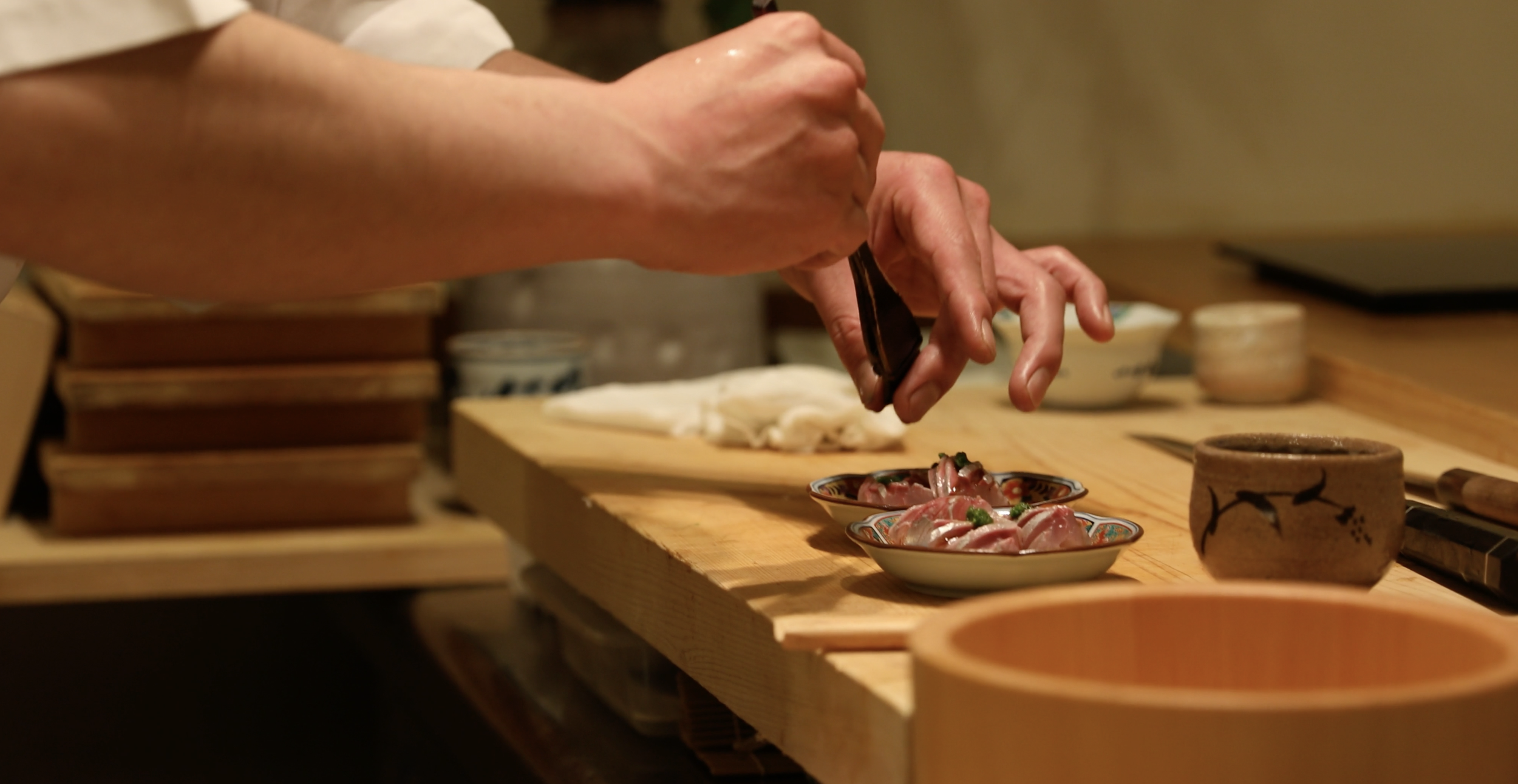 A chef preparing sashimi at Opito Point Lodge - Luxury Beach-side Accommodation in Coromandel, New Zealand
