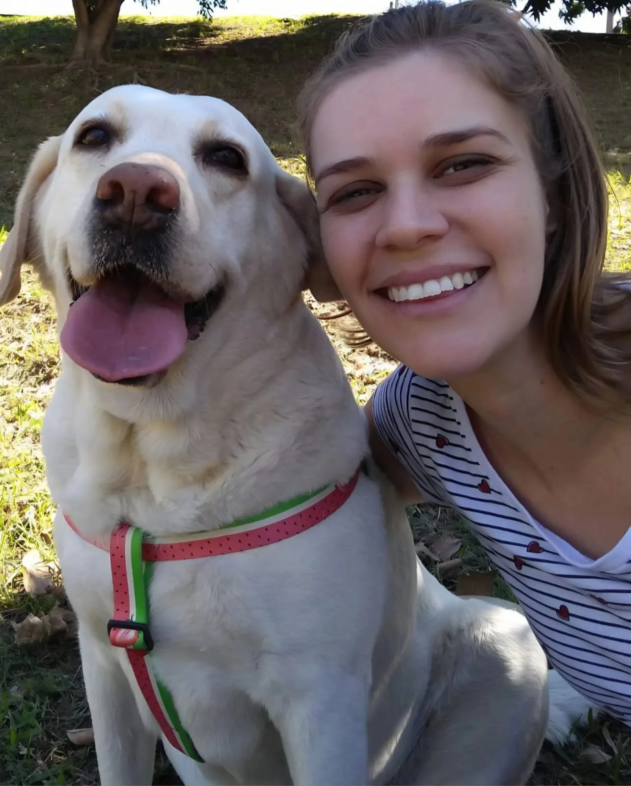 a girl posing with her dog