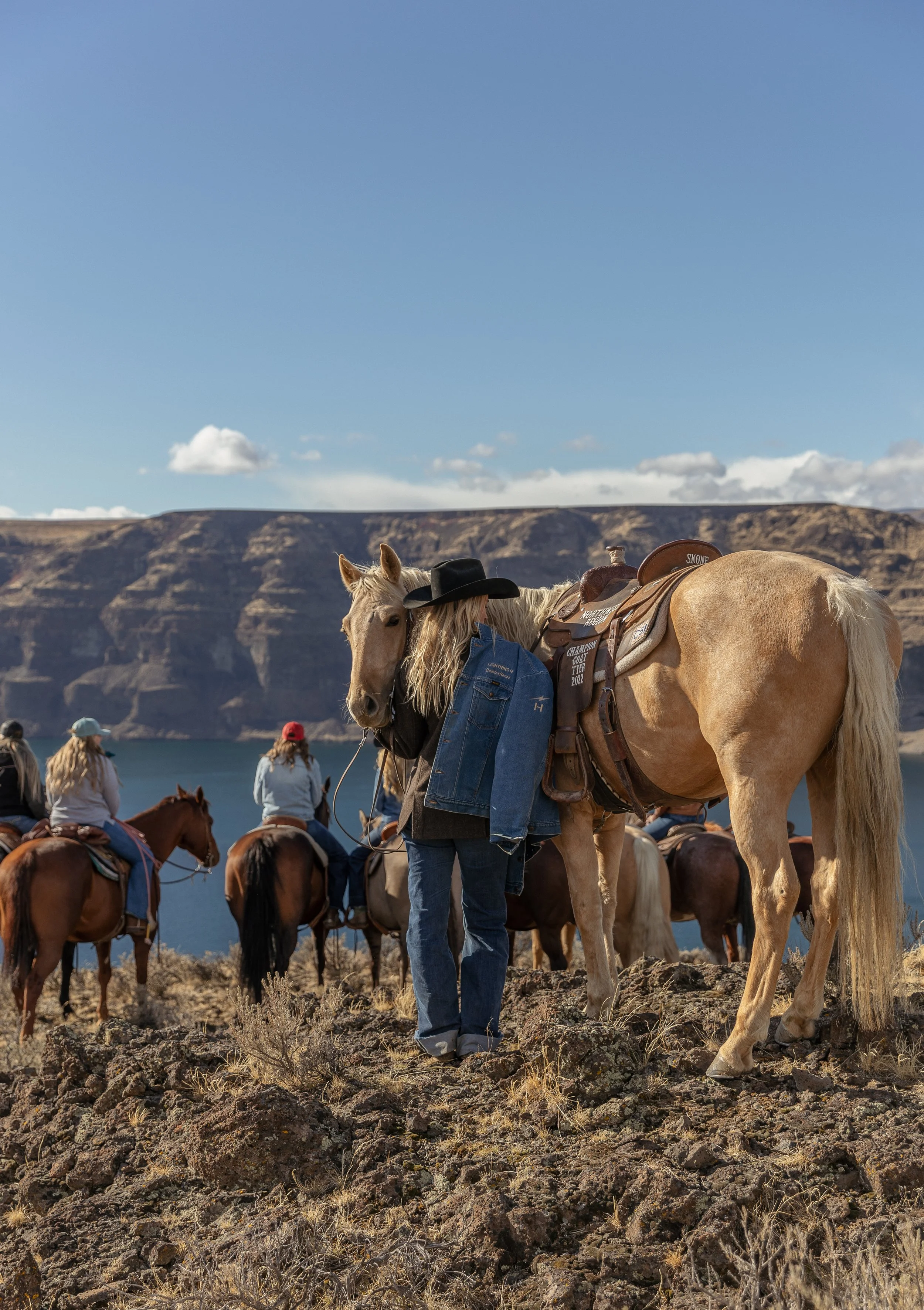 Aubree holds her late stepfather's jacket on a guided horseback trail ride with her rodeo girlfriends at Sagecliffe Resort in Quincy, WA