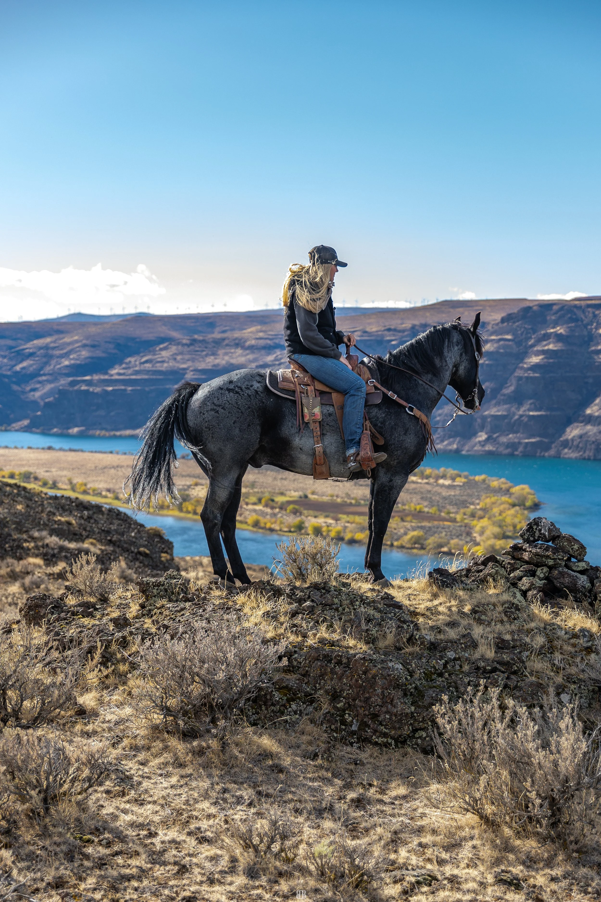 Aubree Skone overlooks the Columbia River on horseback during a guided trail ride at Sagecliffe Resort in Quincy, WA