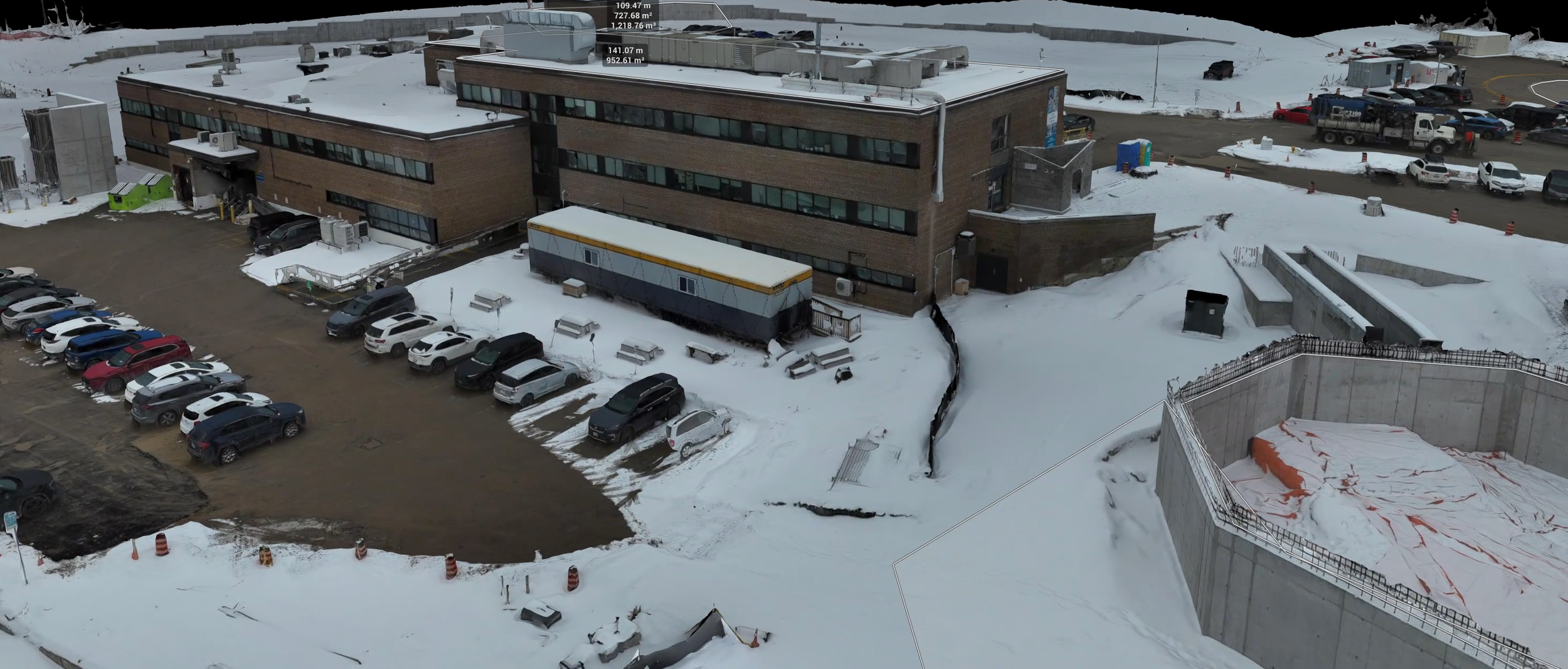 Aerial view of a rural farm with silos, a white building, trees, a dirt road, and grassy fields. Measurement overlay shows a silo height of 18.81 meters.